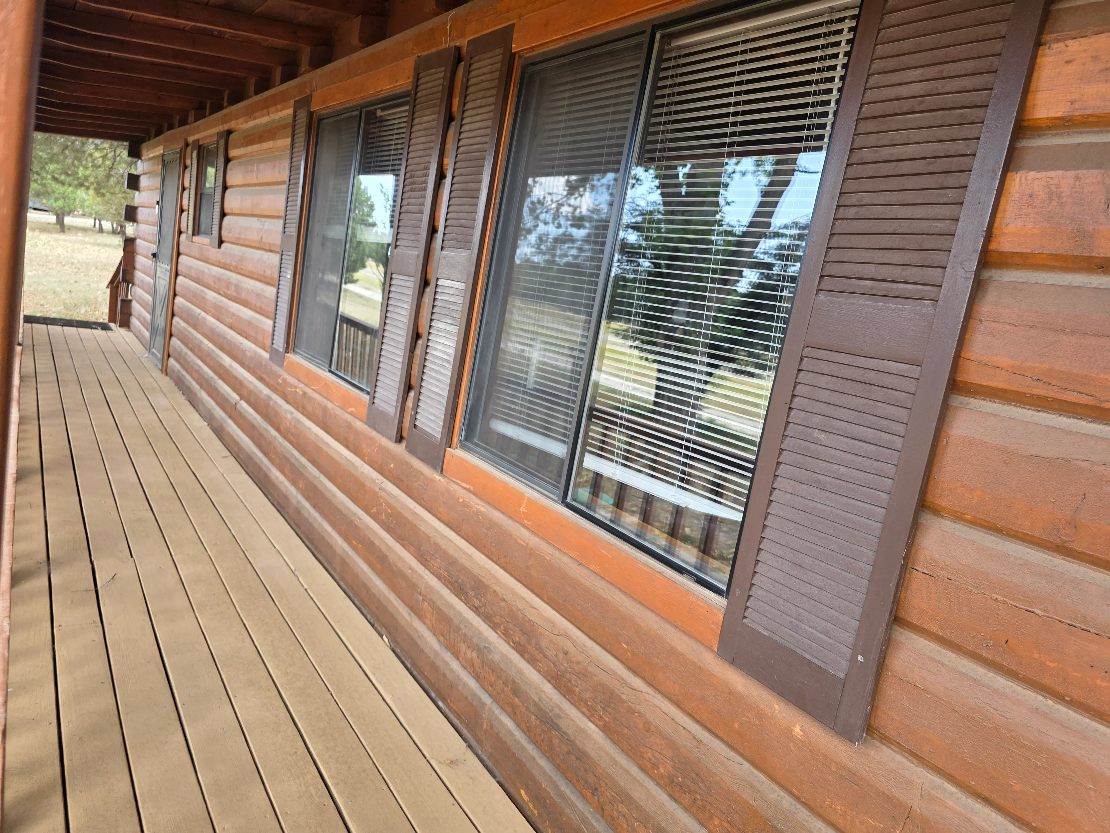 porch along log cabin windows