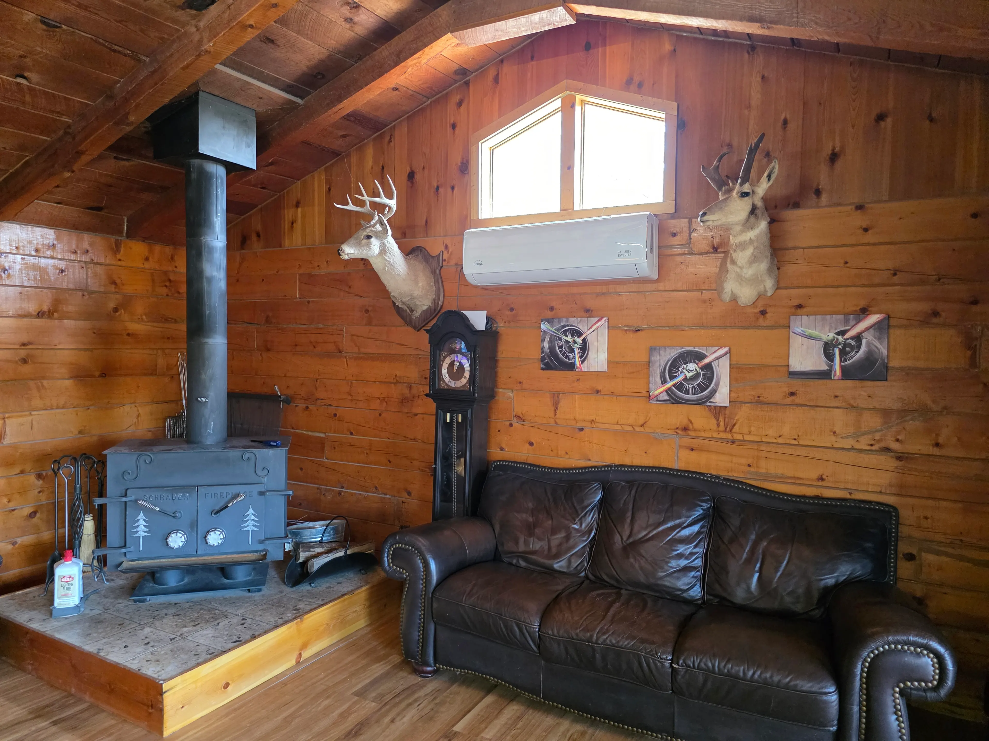 wood stove, sofa, deer mounts
