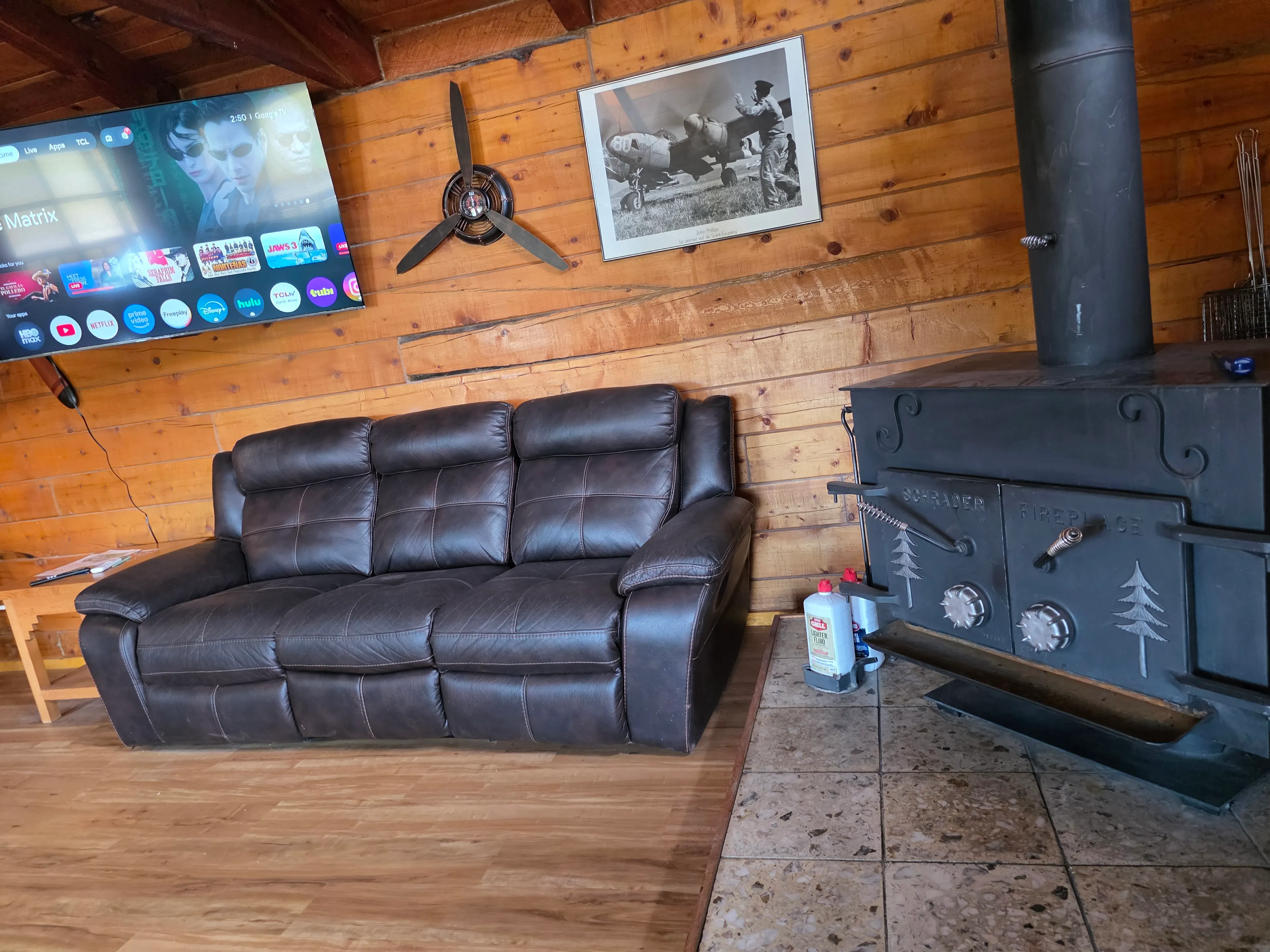 TV, leather sofa, wood stove