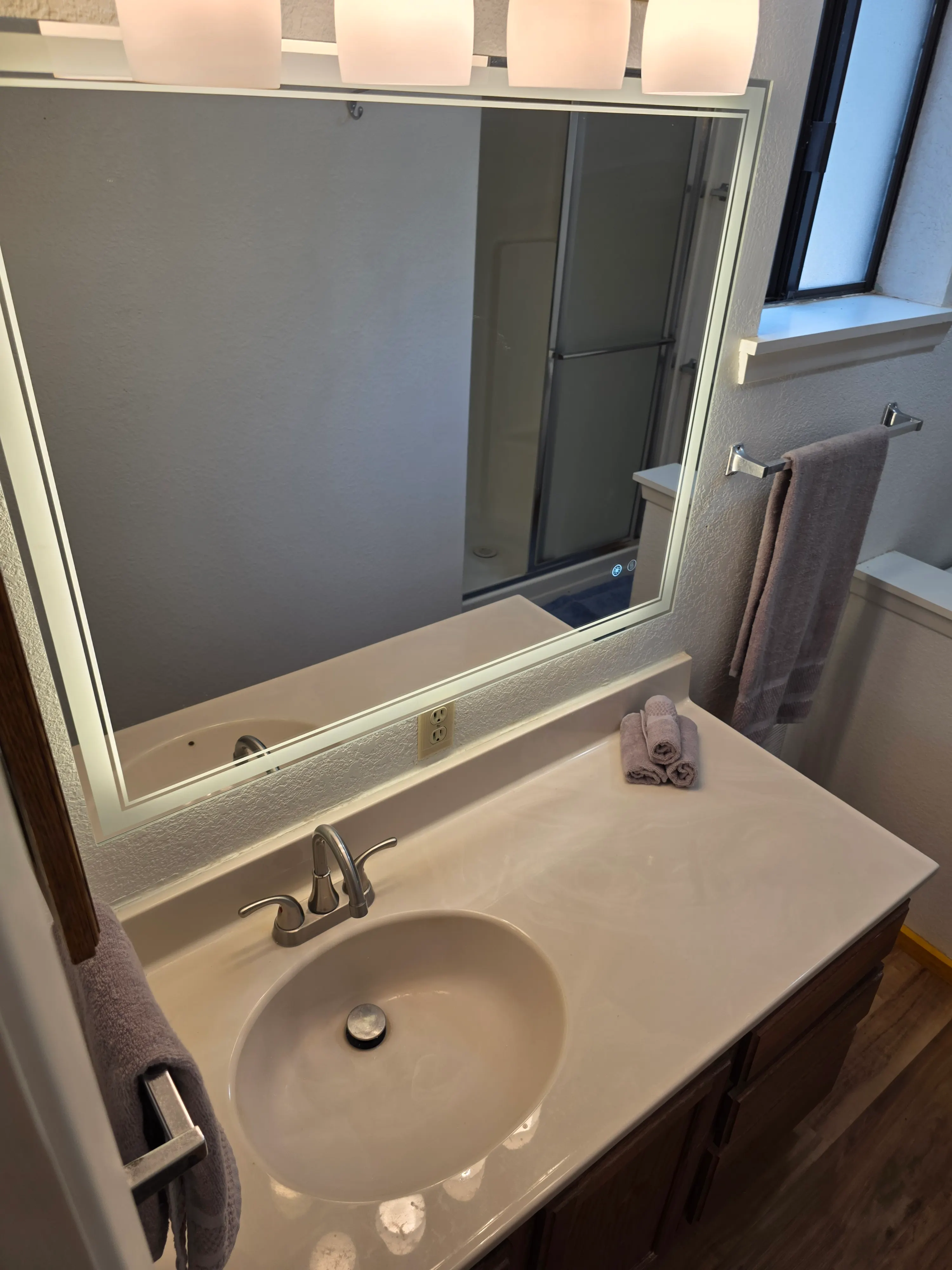 bathroom vanity with lit mirror