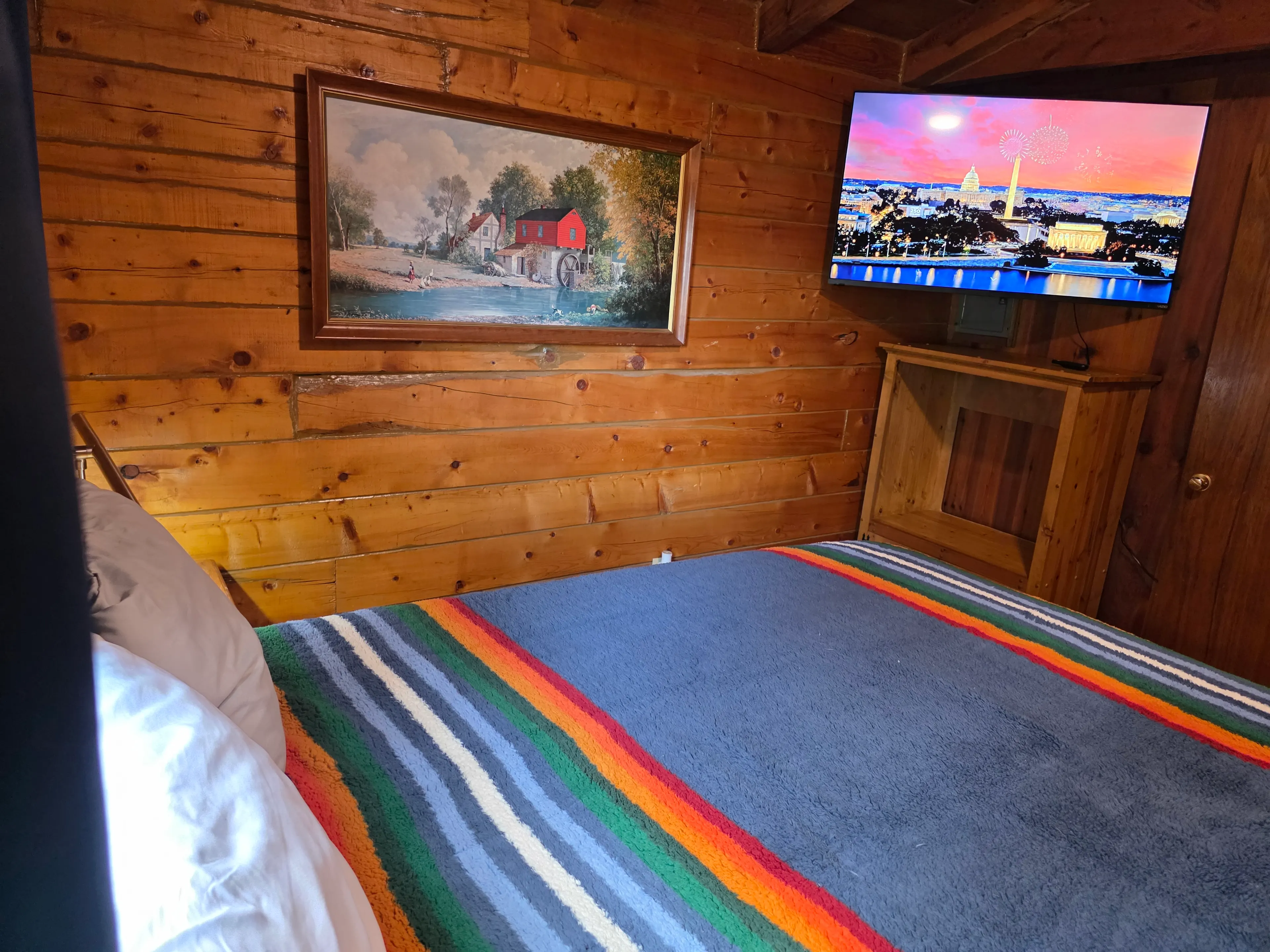 log-wall bedroom with TV