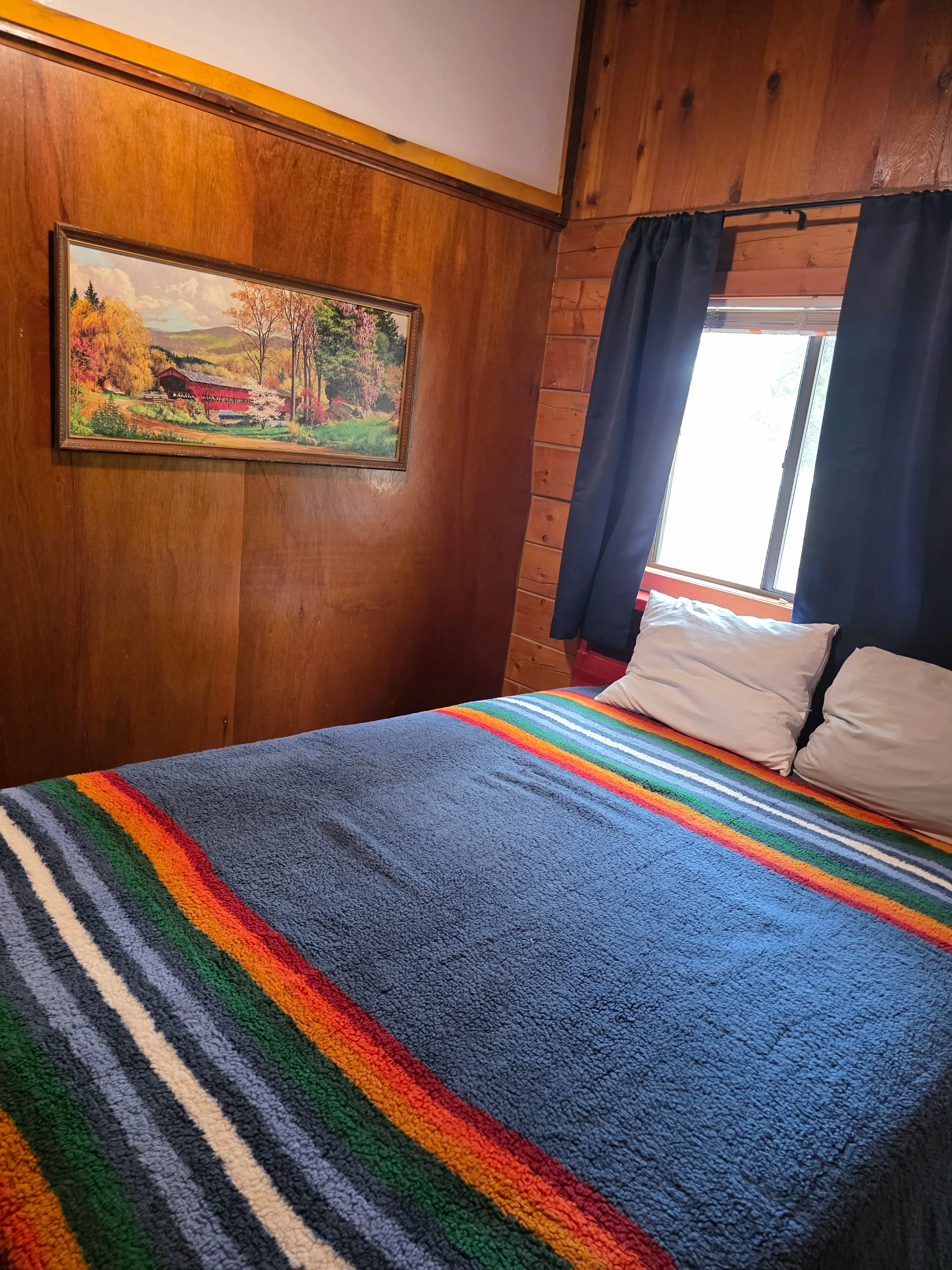 queen bed by curtained window