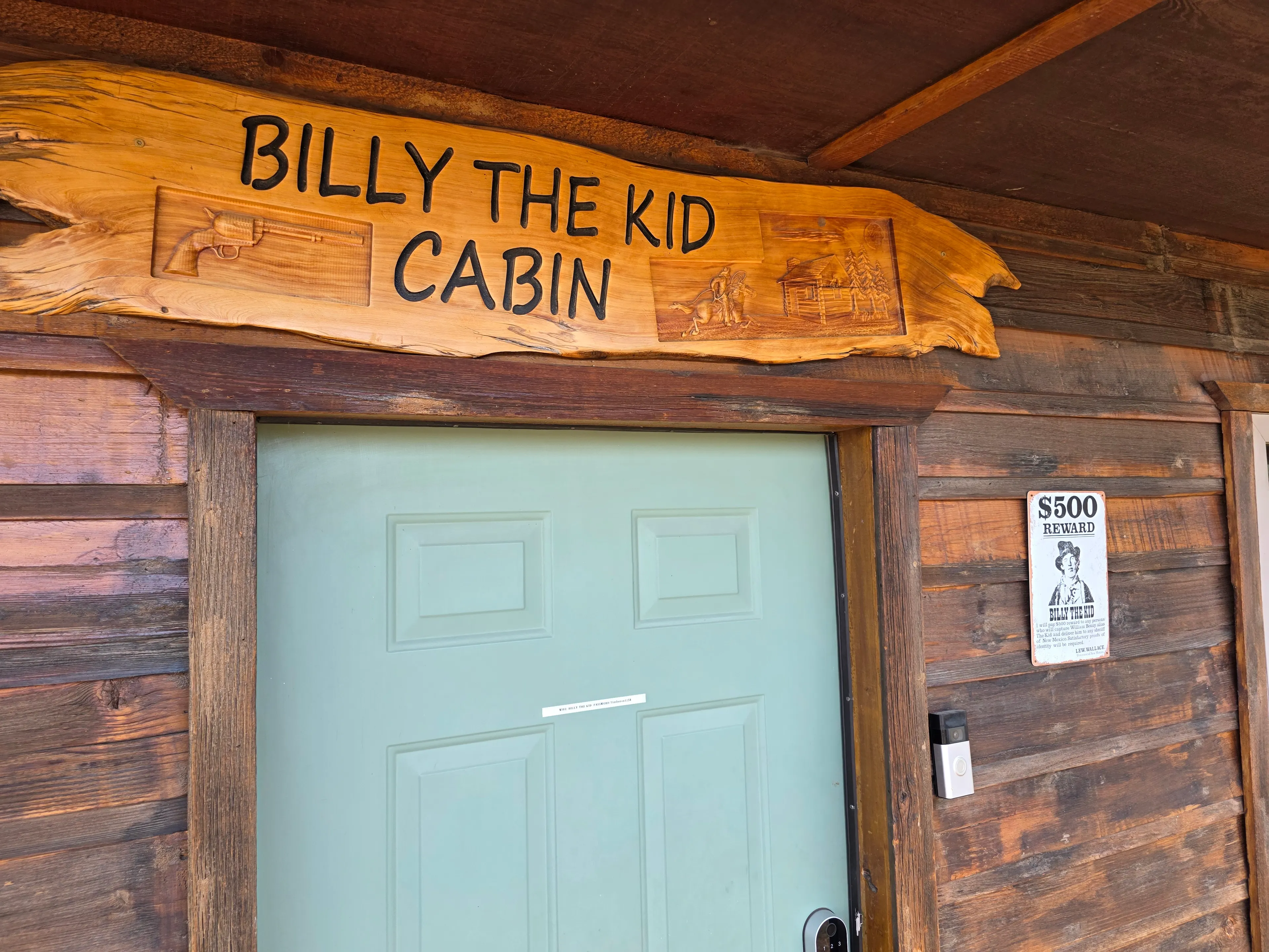carved cabin name sign over door