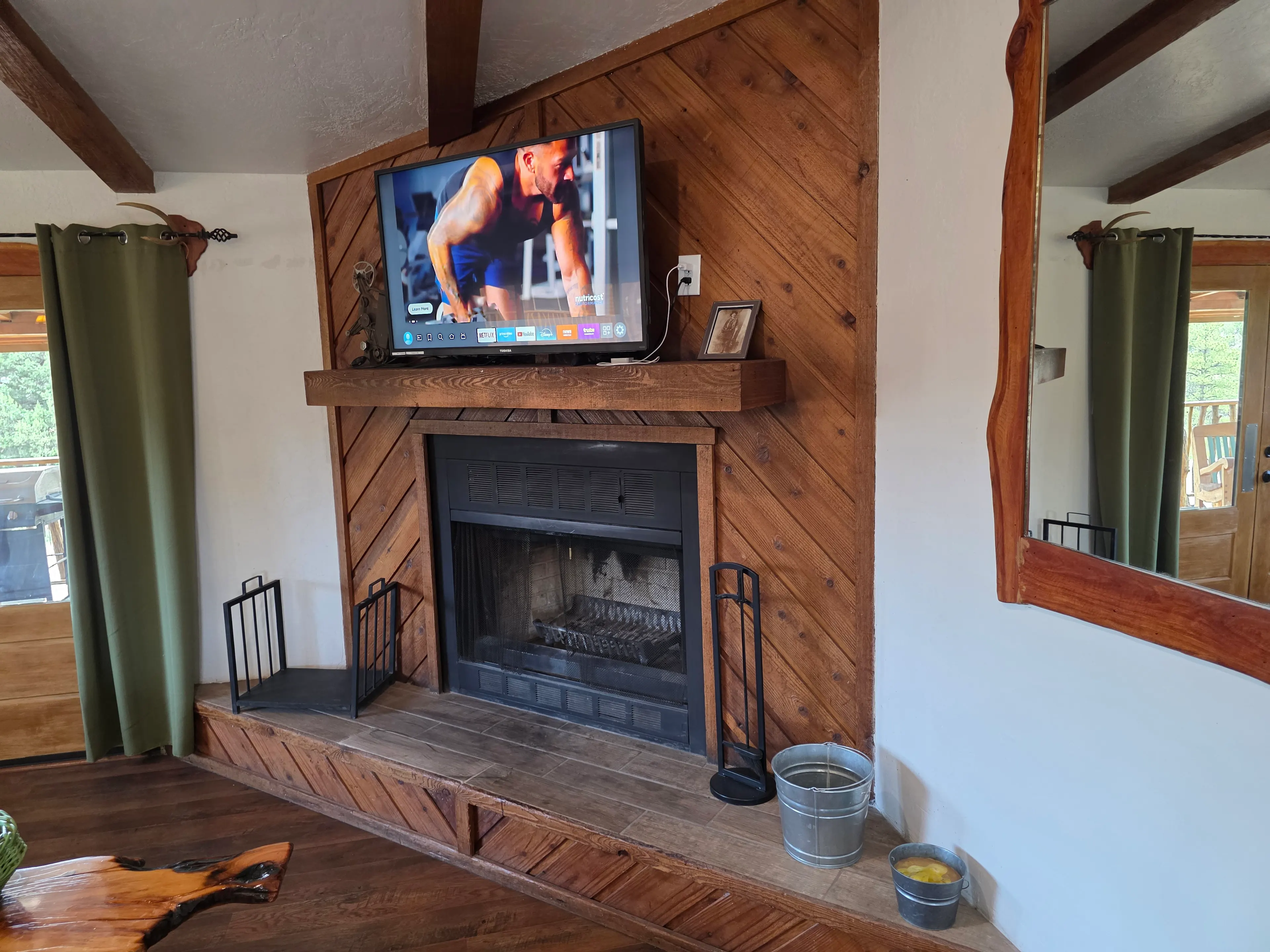 TV above wood-clad fireplace