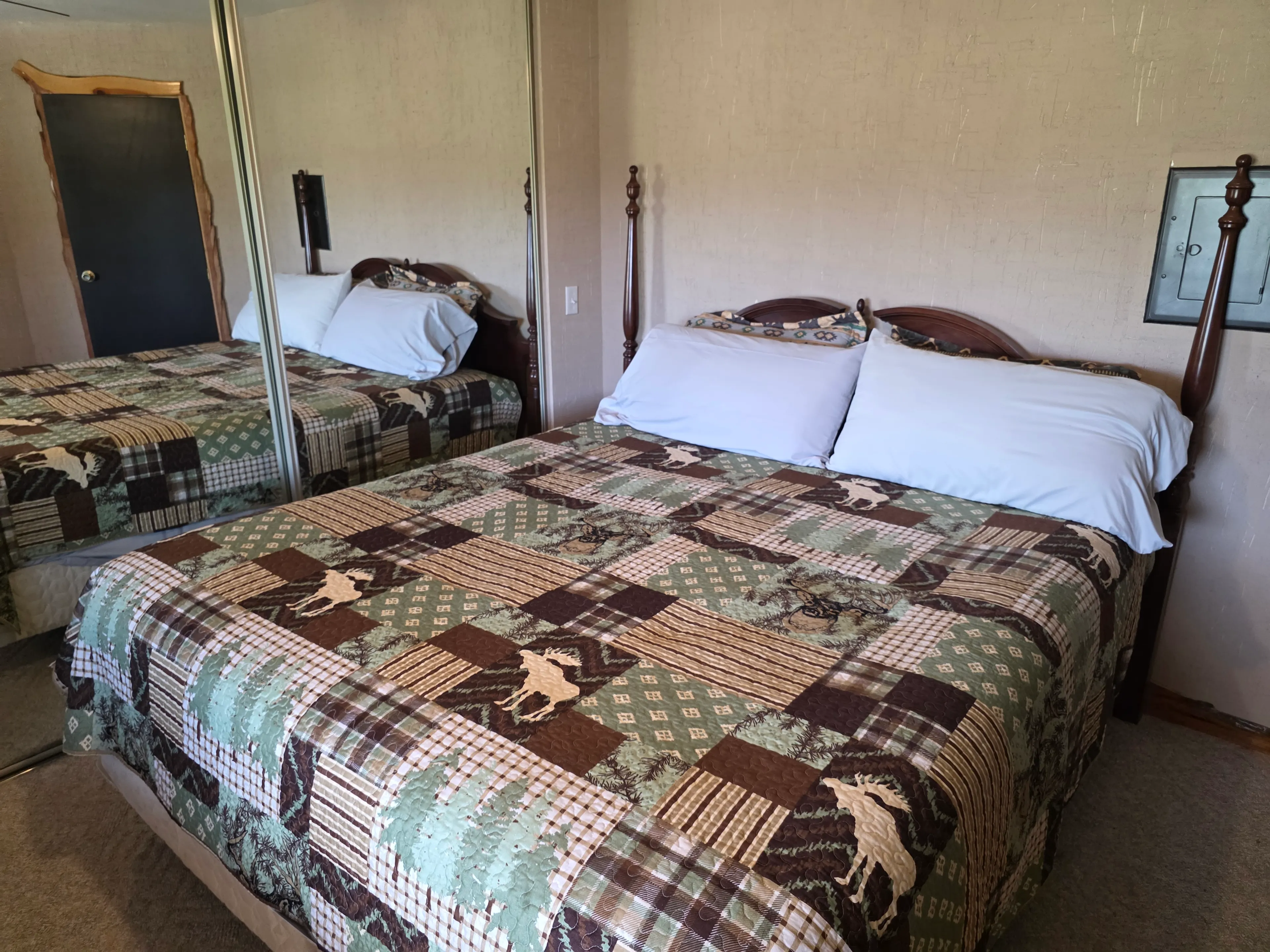 queen bed with moose quilt