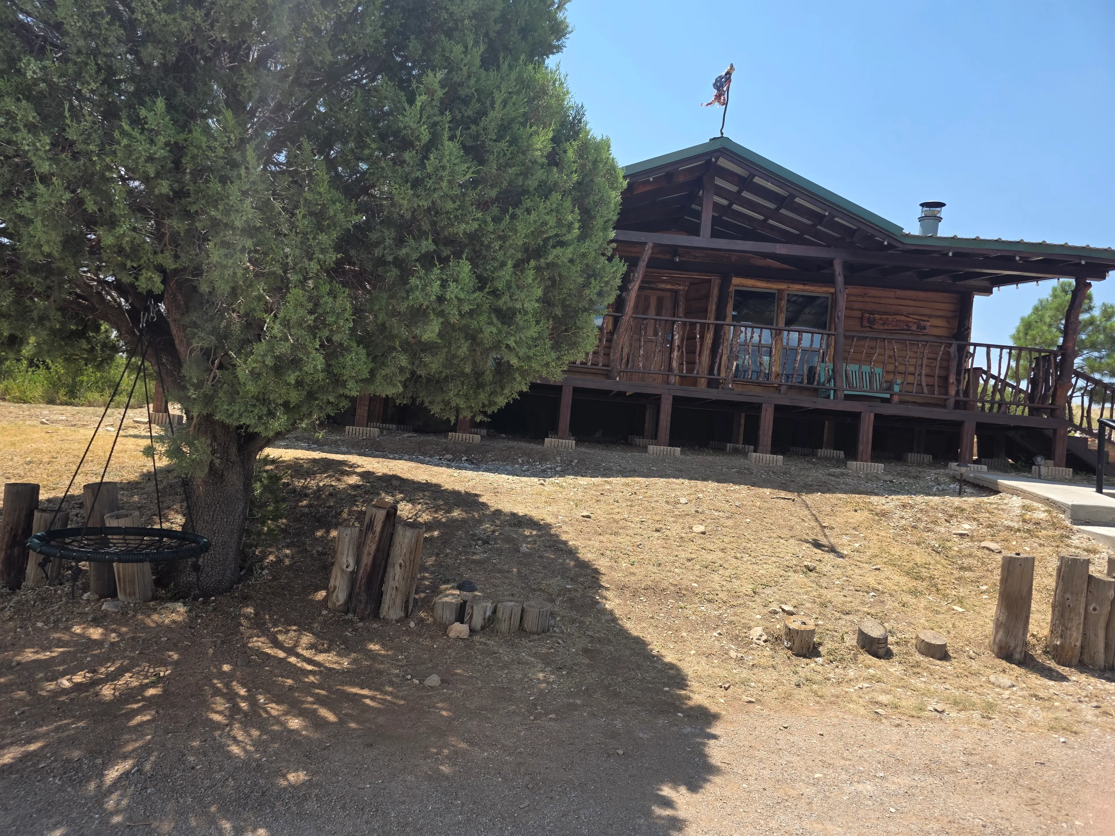 log cabin exterior with tree swing