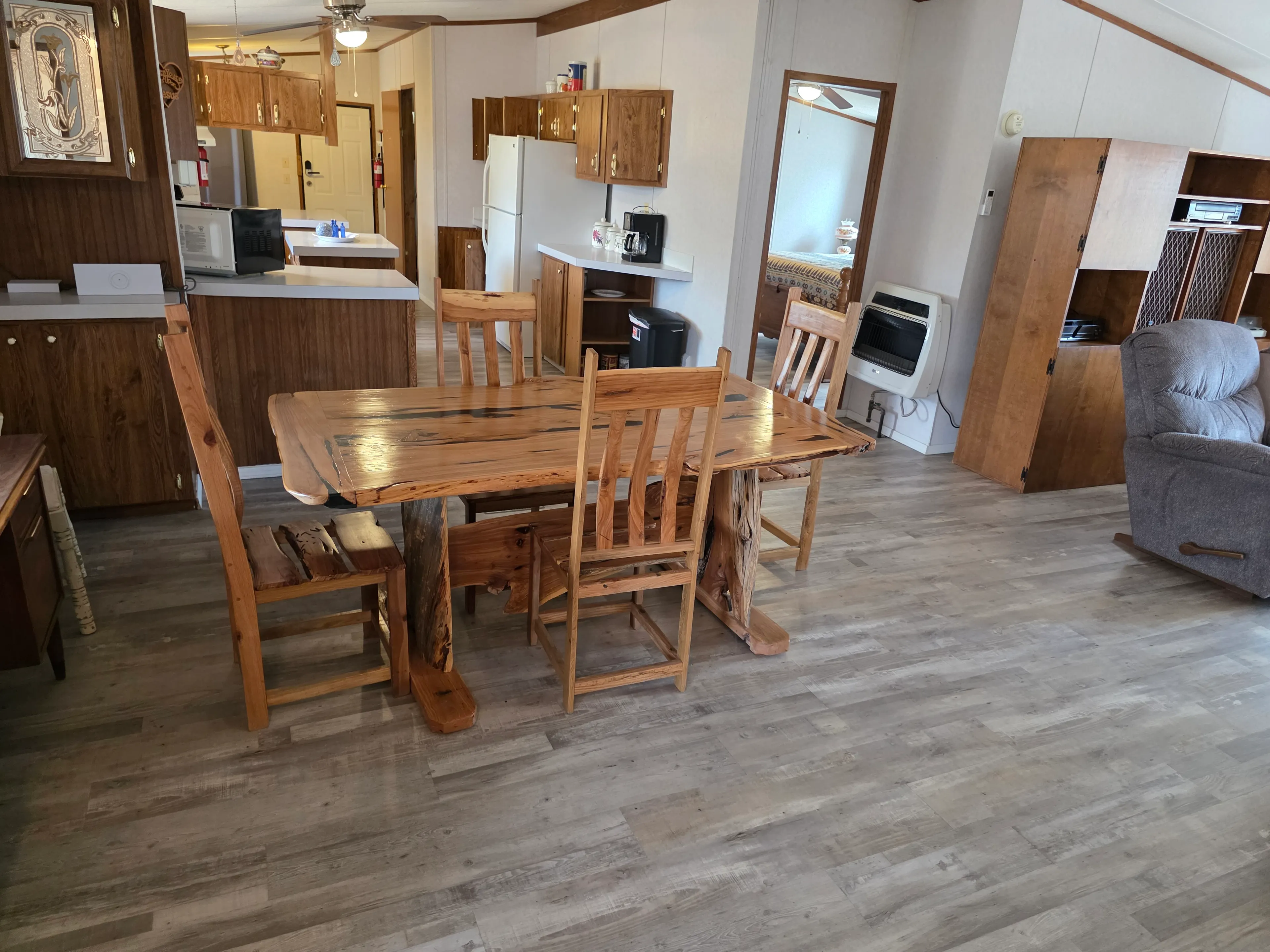 Rustic wood dining table, kitchen behind