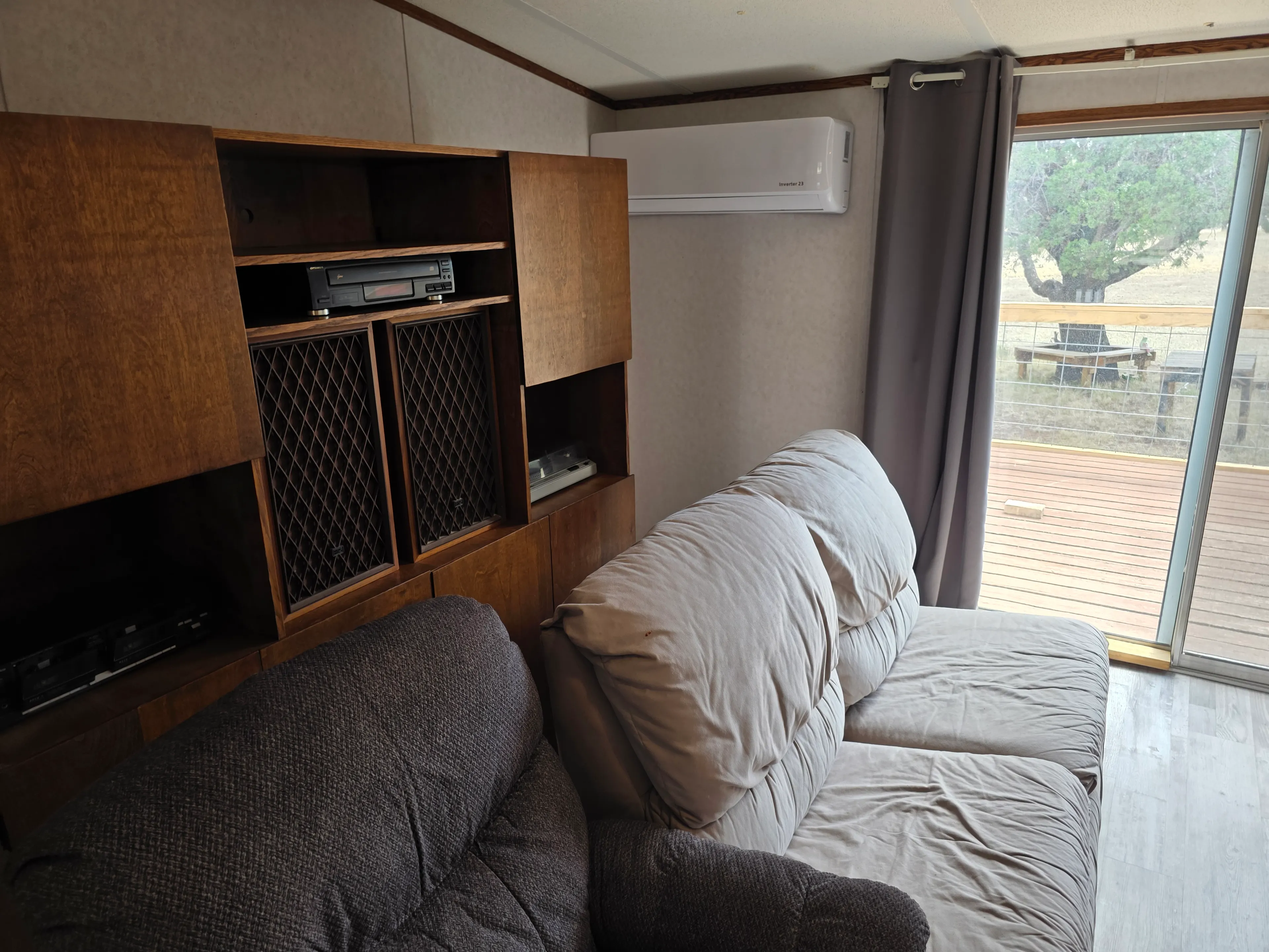 Sofas, entertainment shelving, deck door