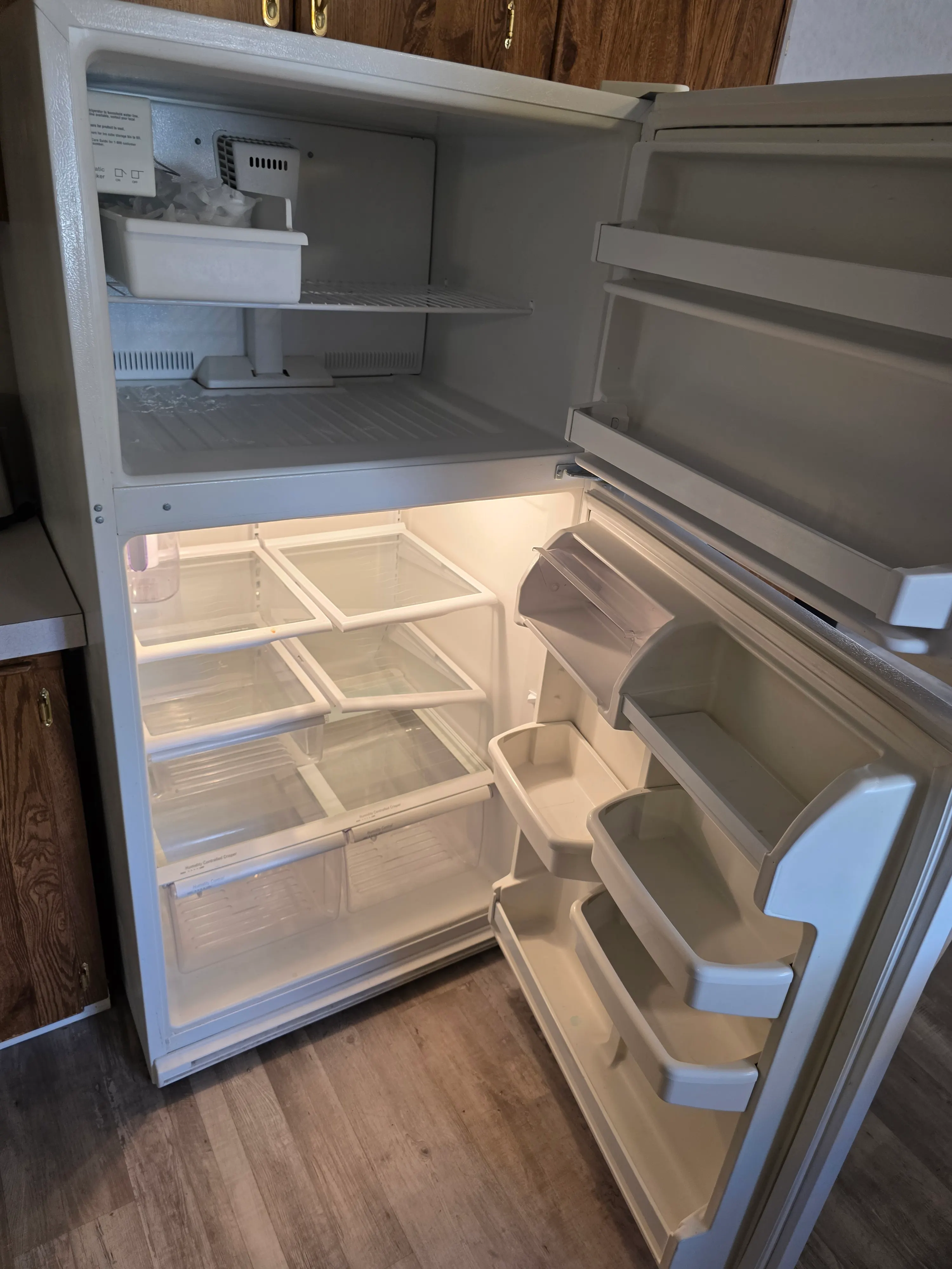Open empty refrigerator and freezer