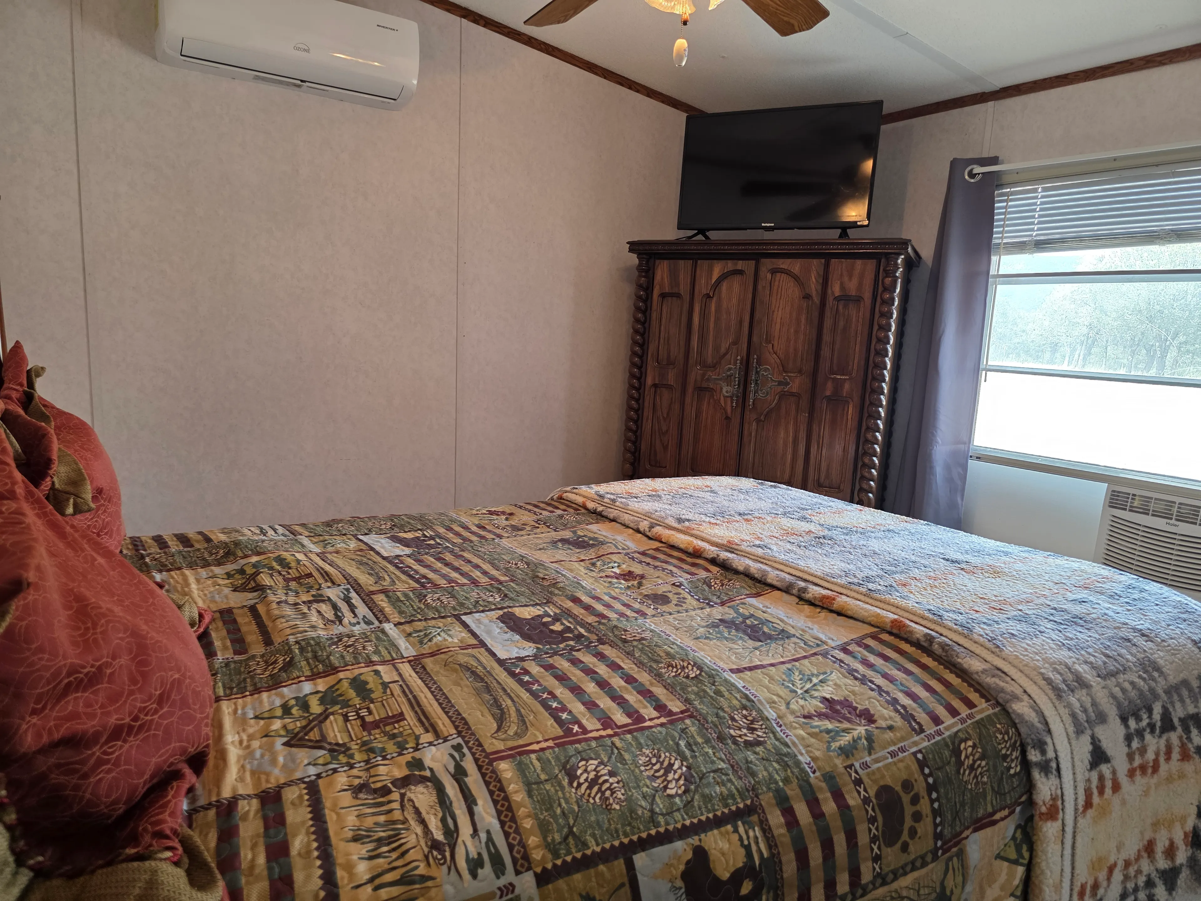 Bedroom with TV atop armoire