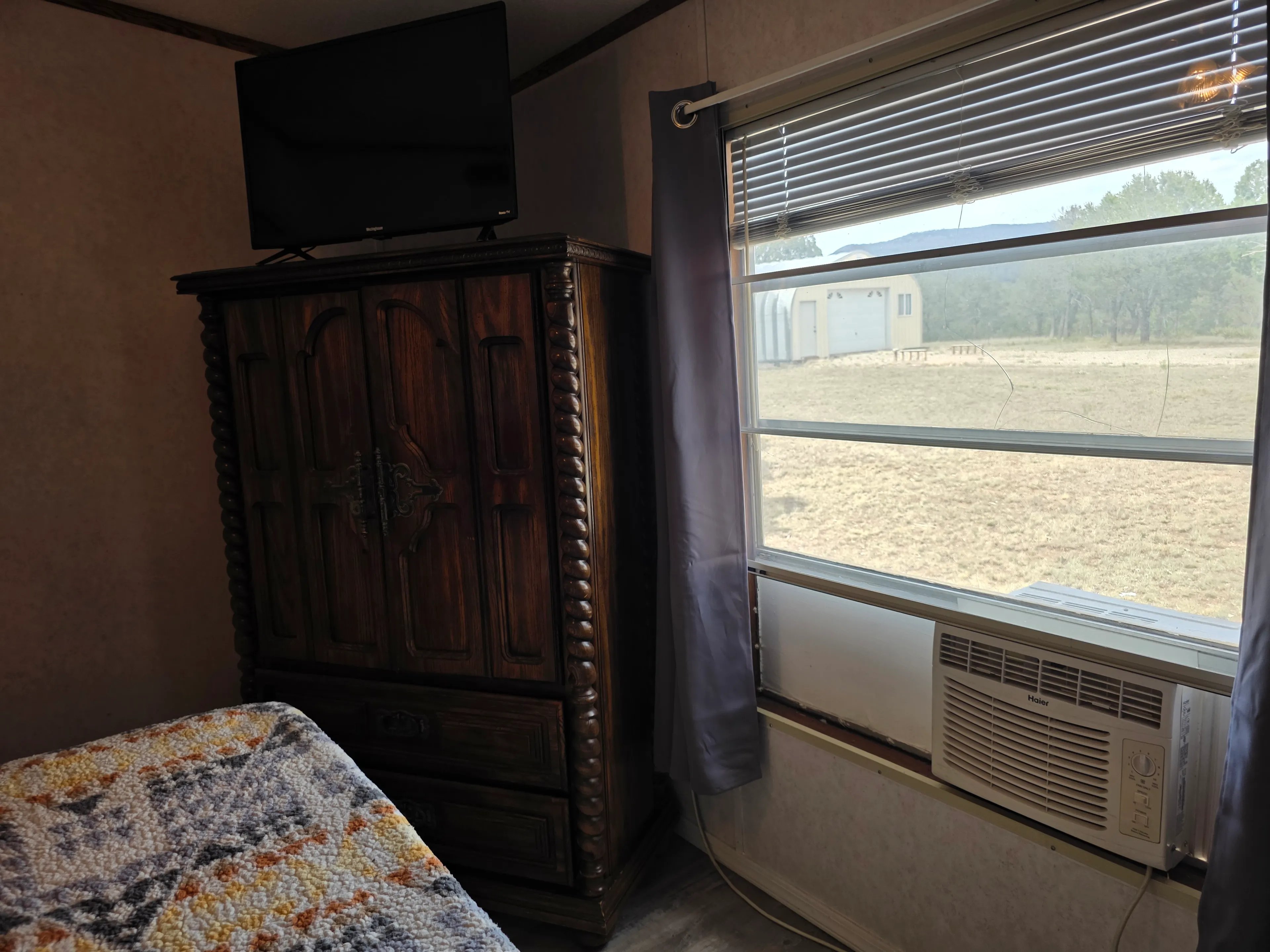 Armoire, TV, window AC, view