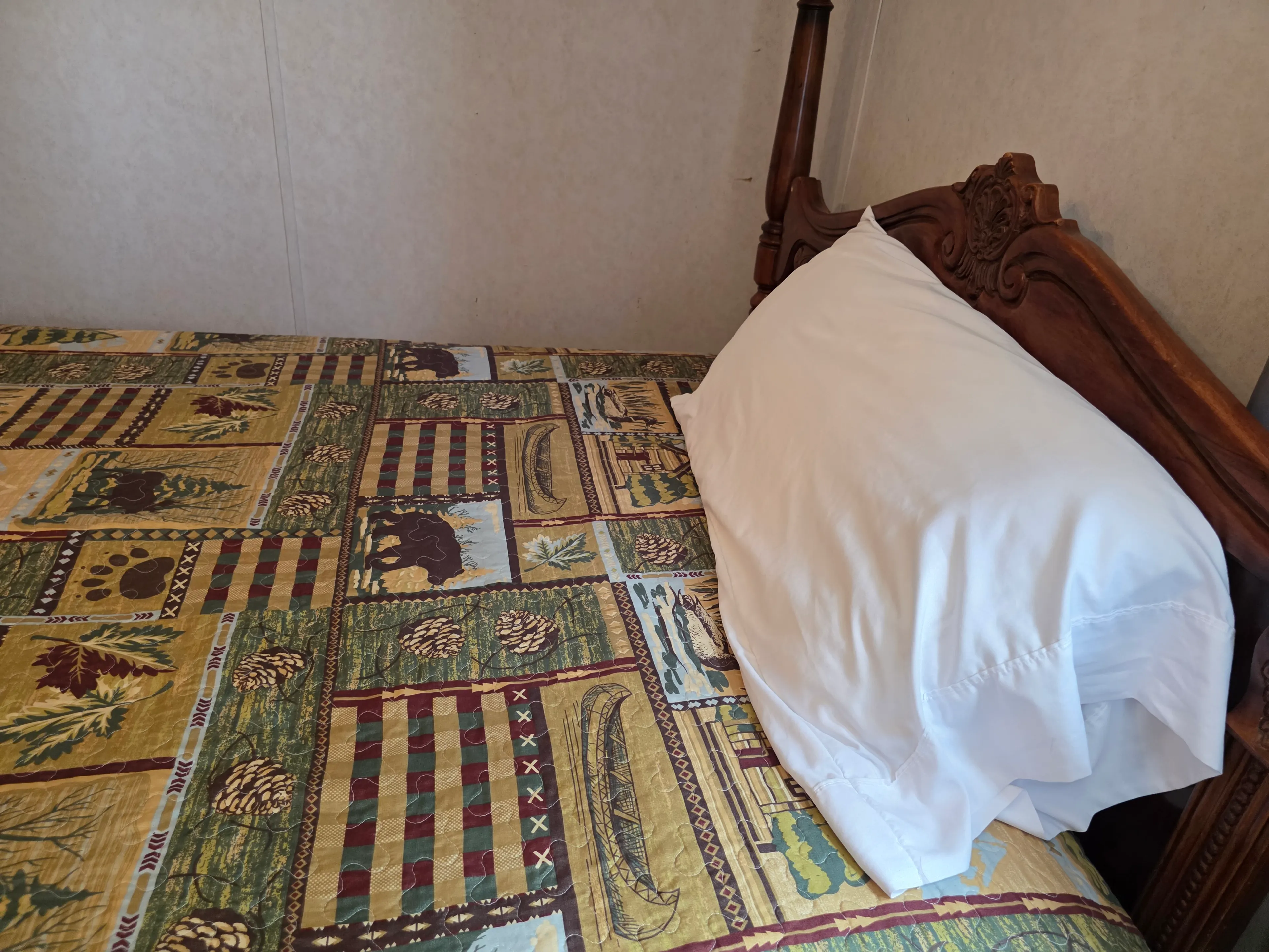 Close-up of bed pillow, headboard