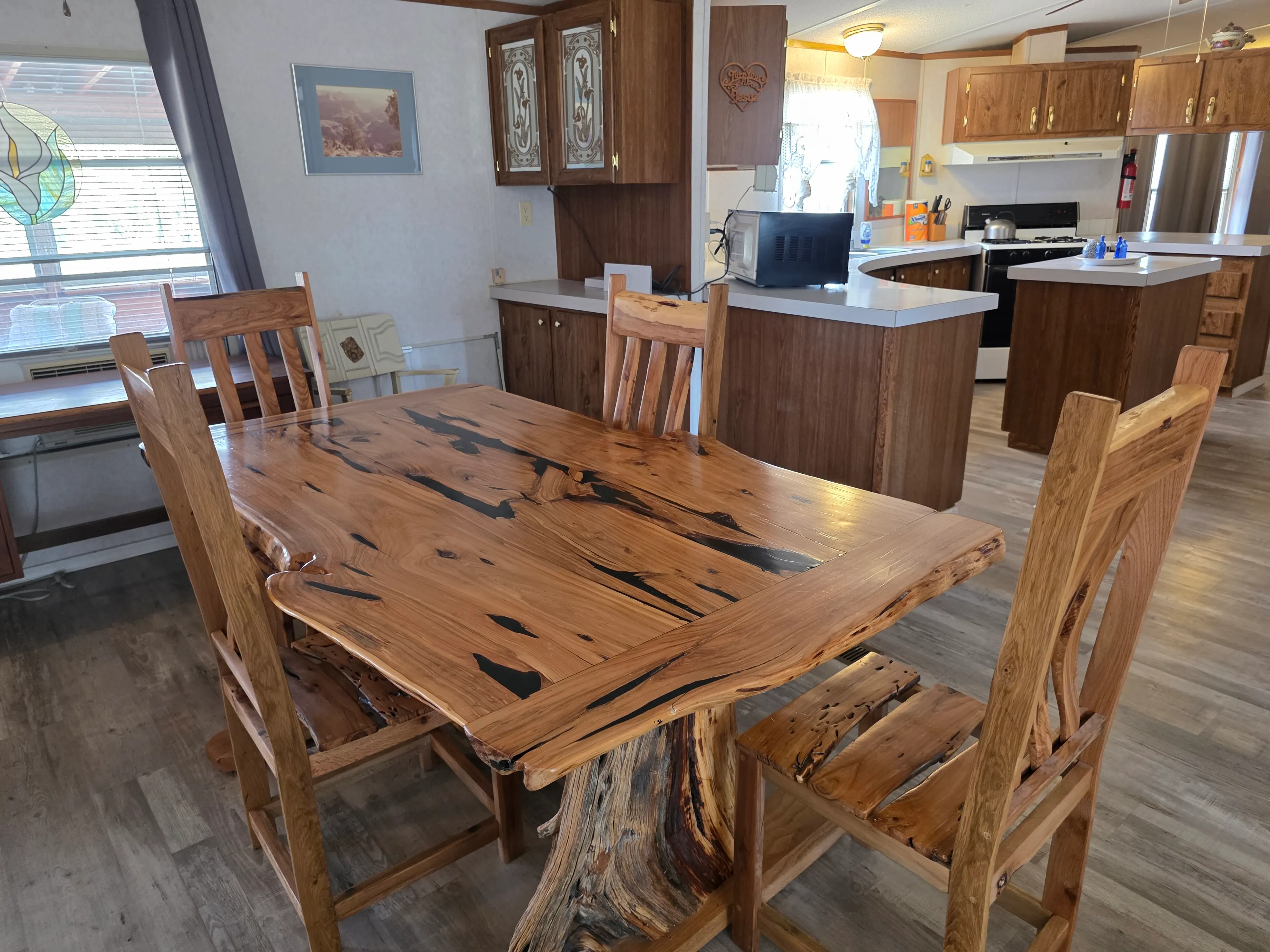 Rustic wood dining table, kitchen behind