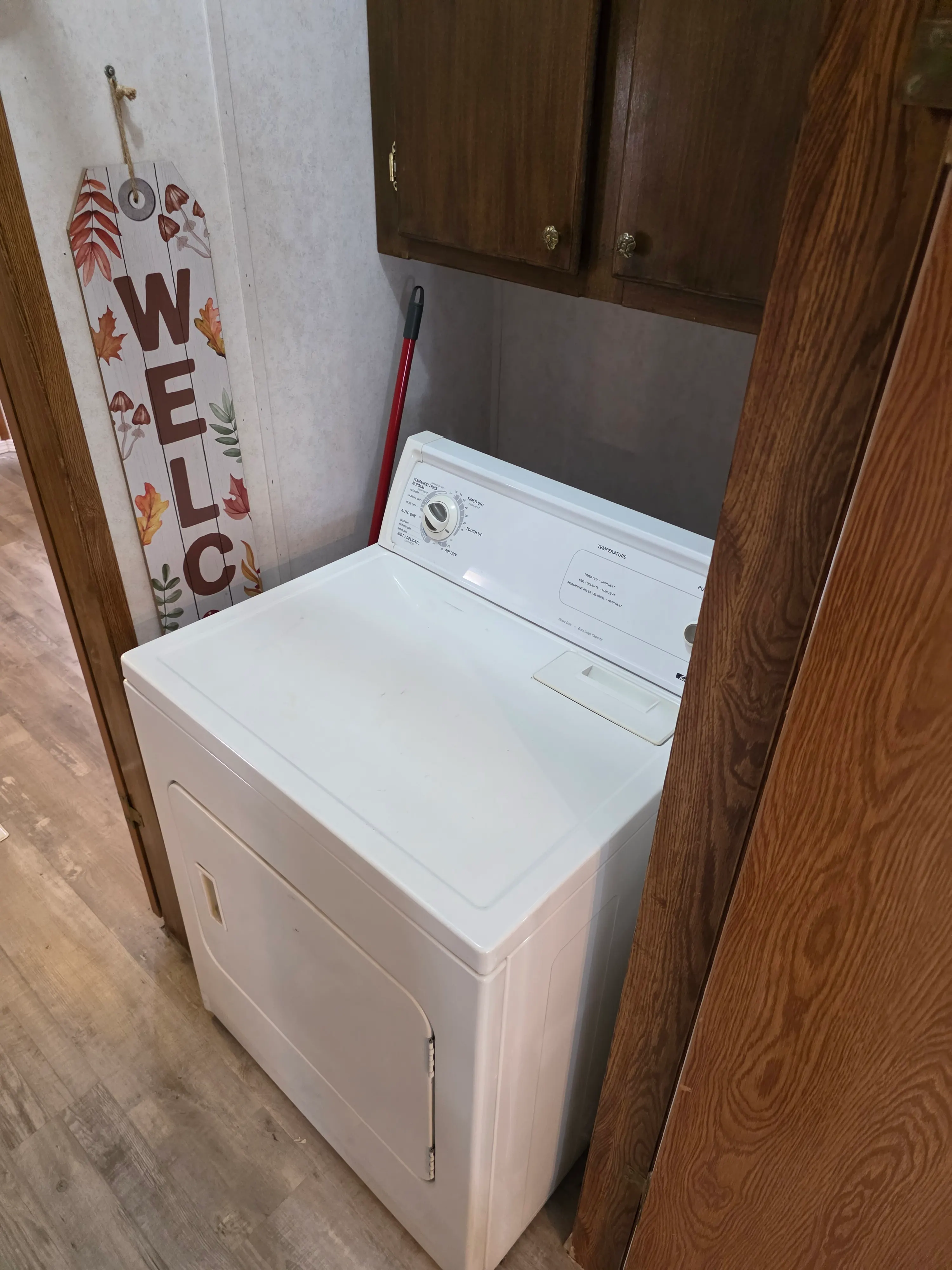 Dryer in laundry nook, welcome sign