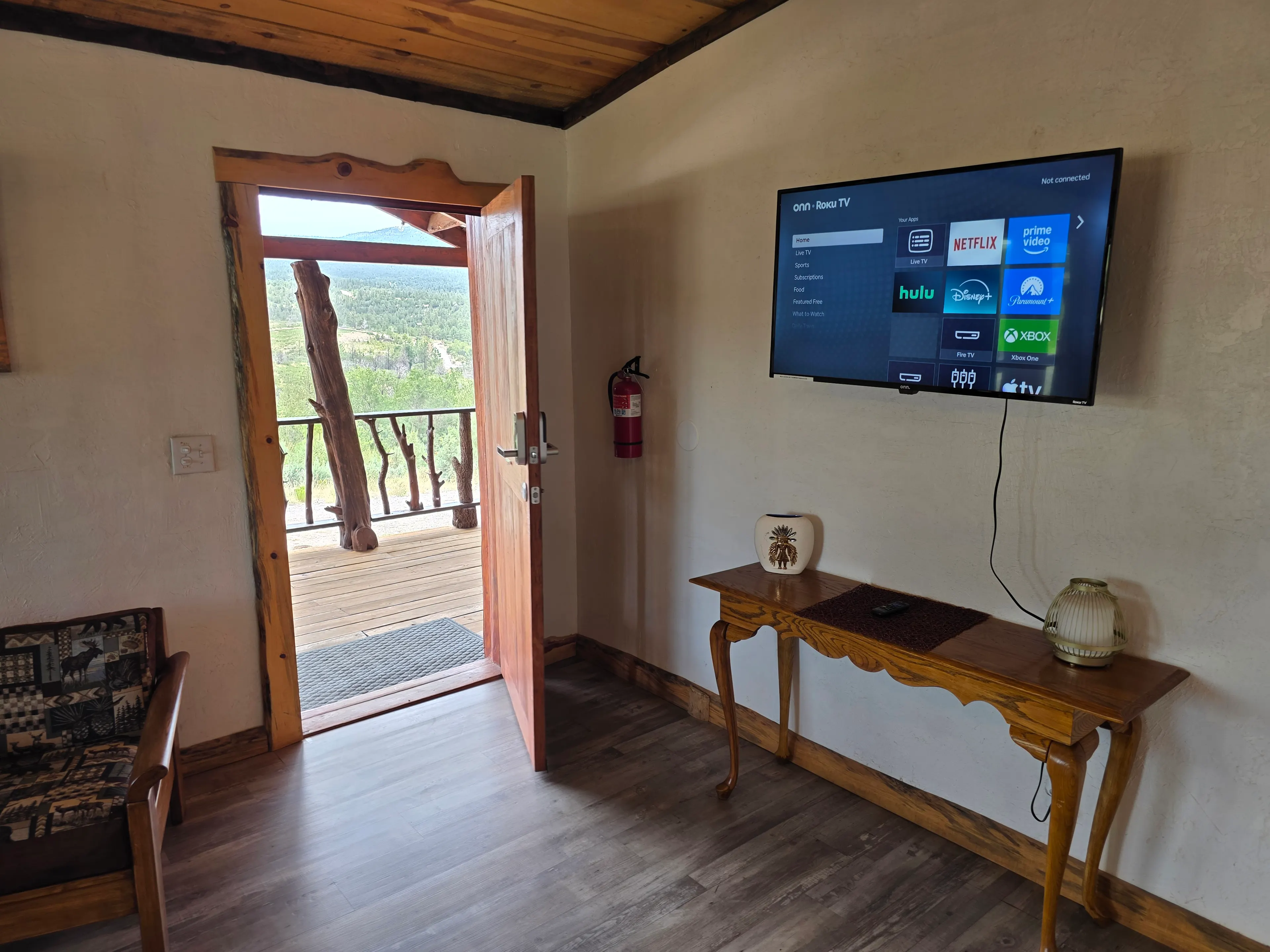 entry door open, wall-mounted TV