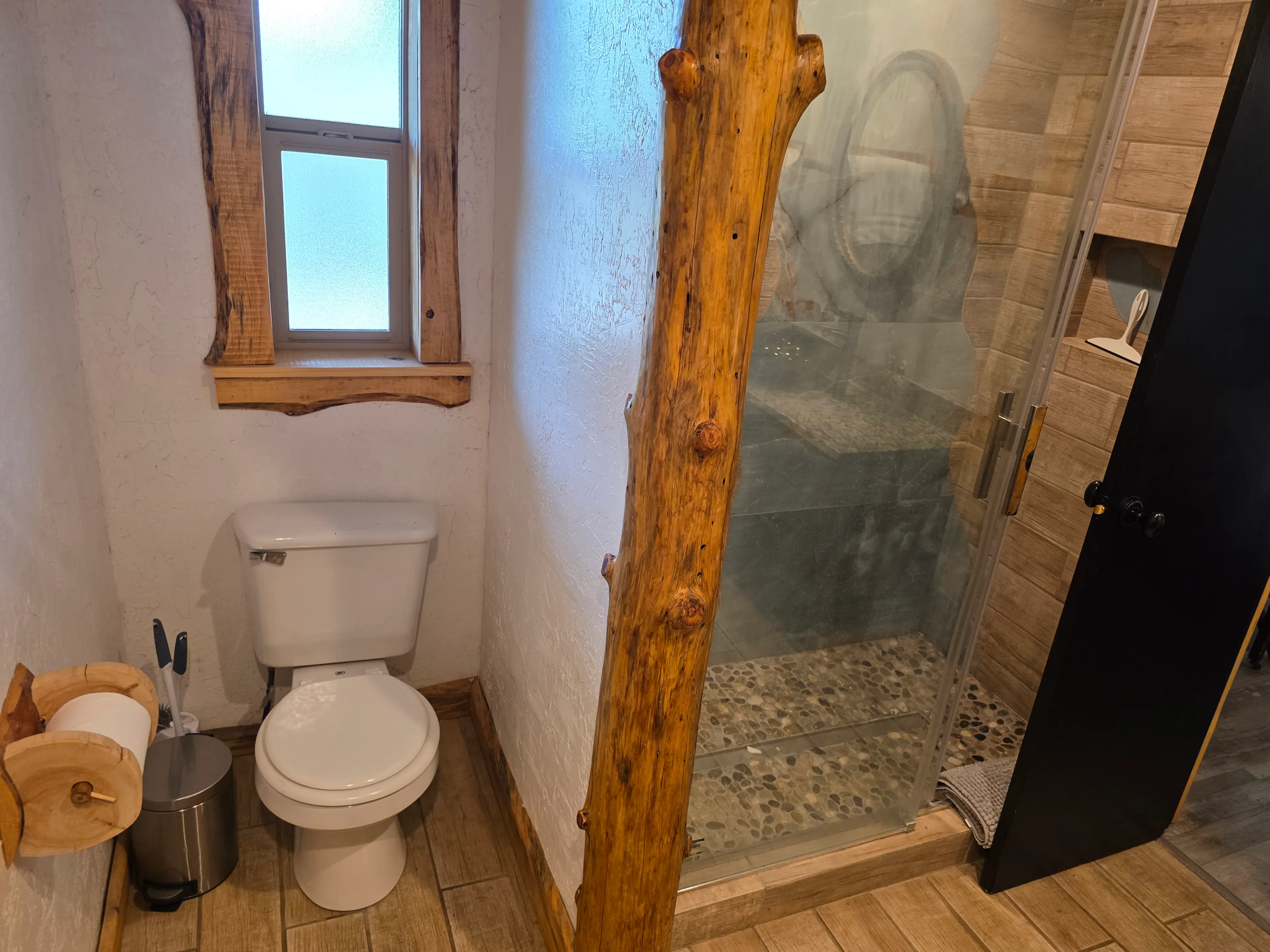 toilet and pebble-floor shower