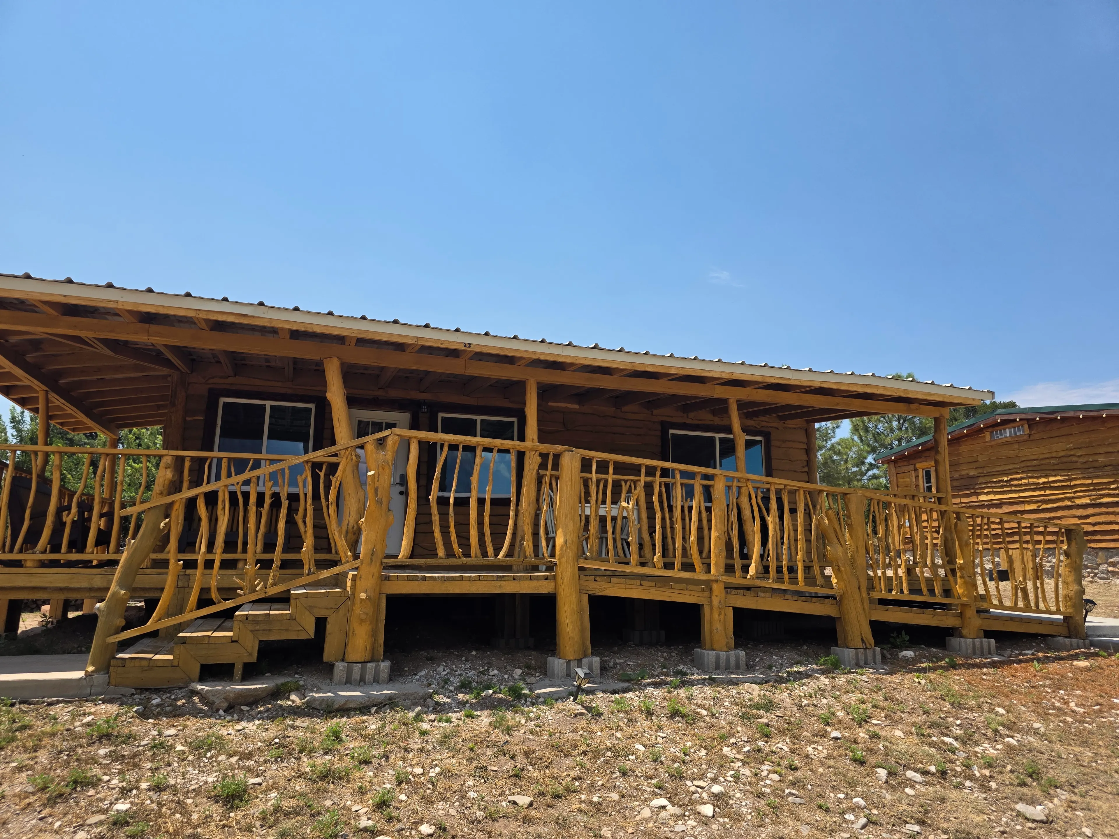 wide cabin front with log porch