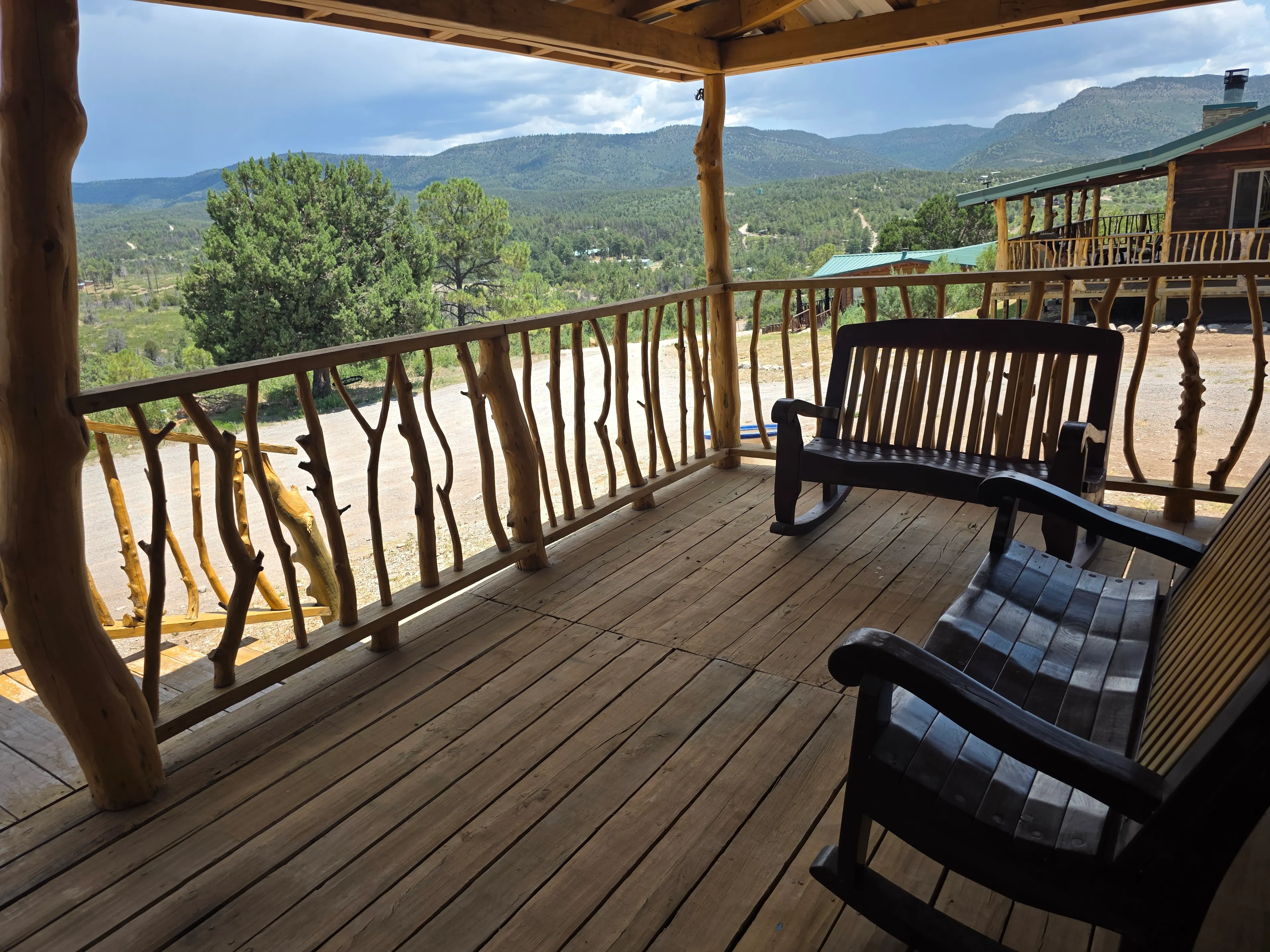 covered deck, rocking benches, mountain view
