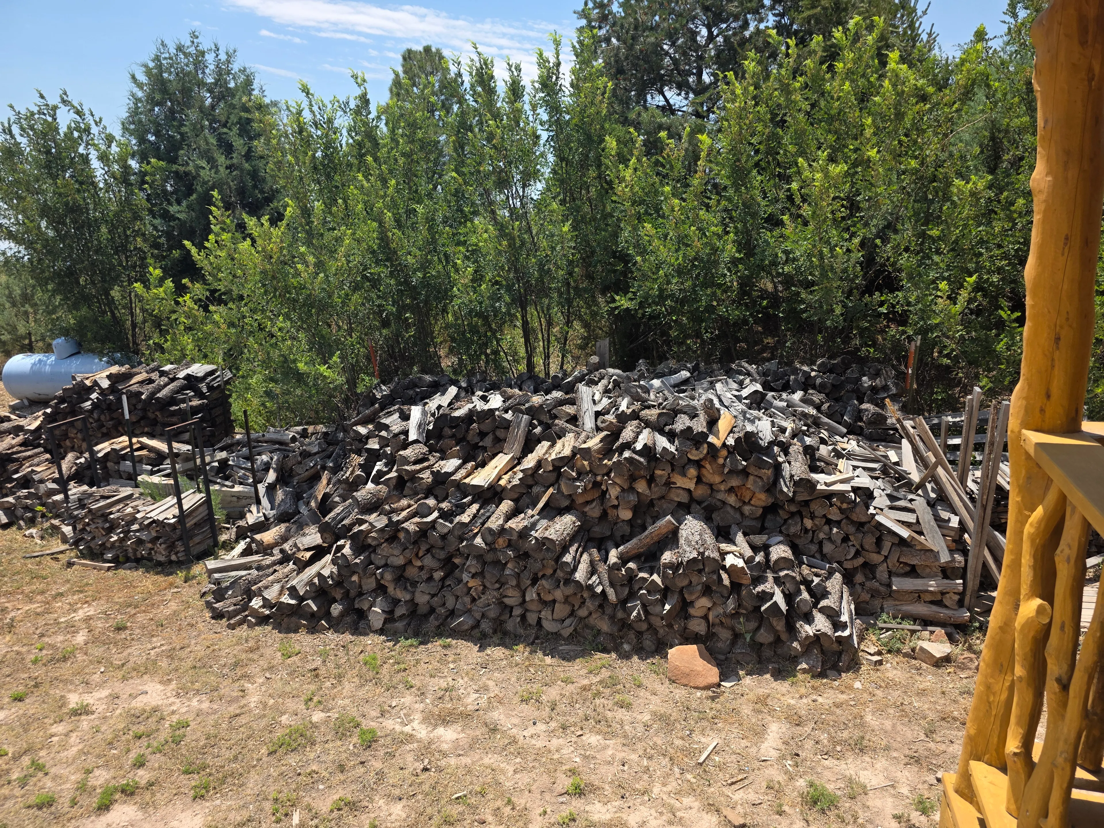 large stacked firewood piles outside