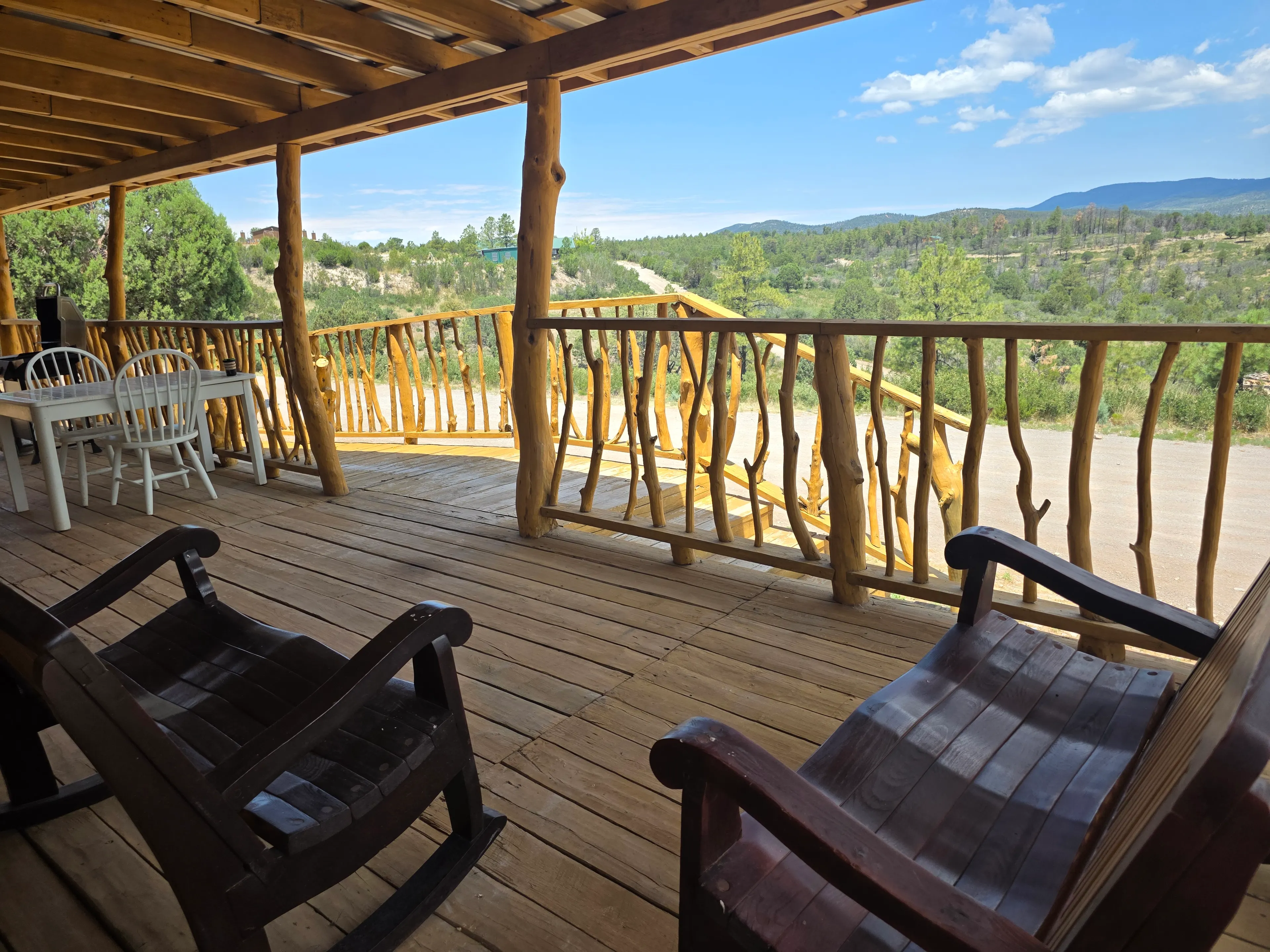 deck with outdoor dining table, view