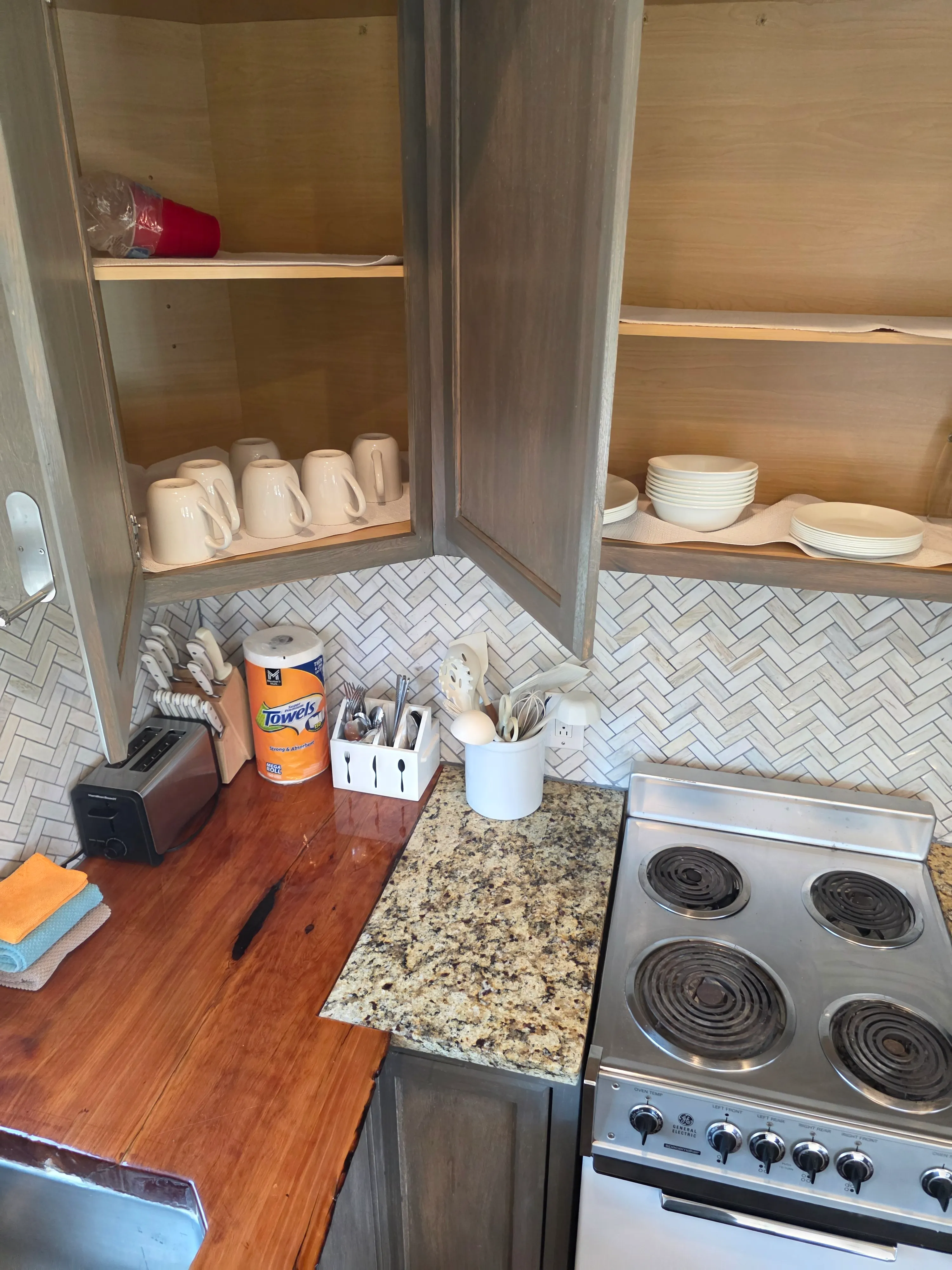 stocked kitchen cabinets, mugs, dishes