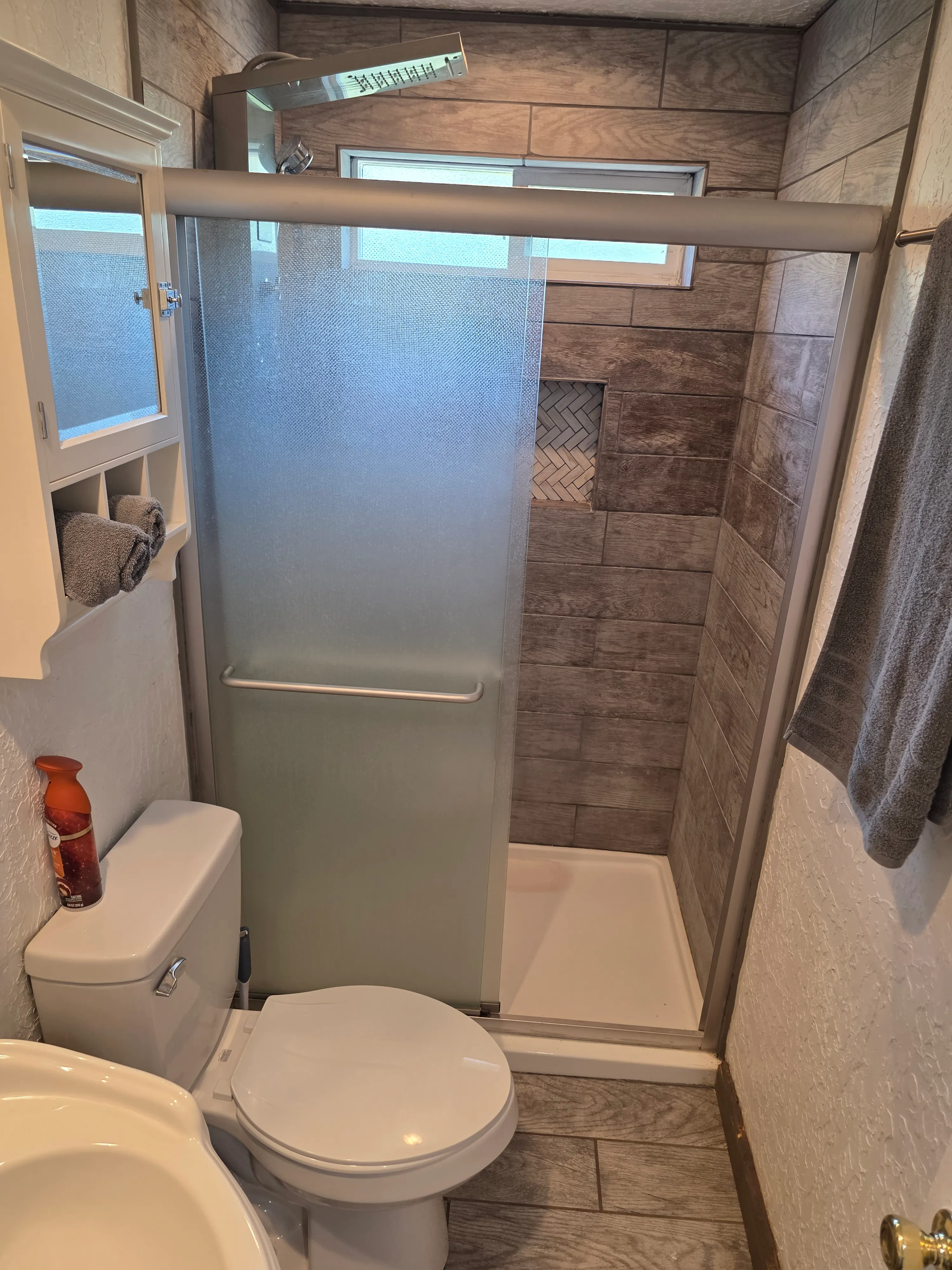 tiled walk-in shower with glass door