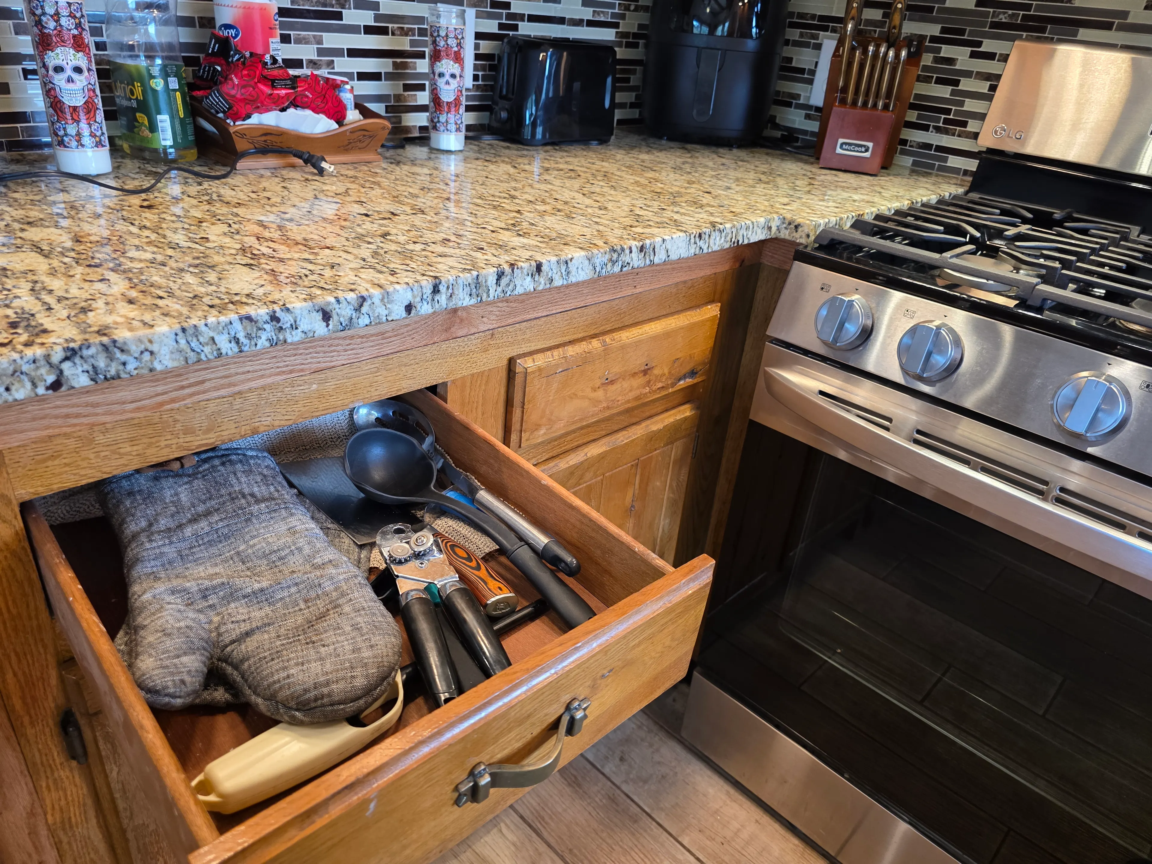 utensil drawer open by oven