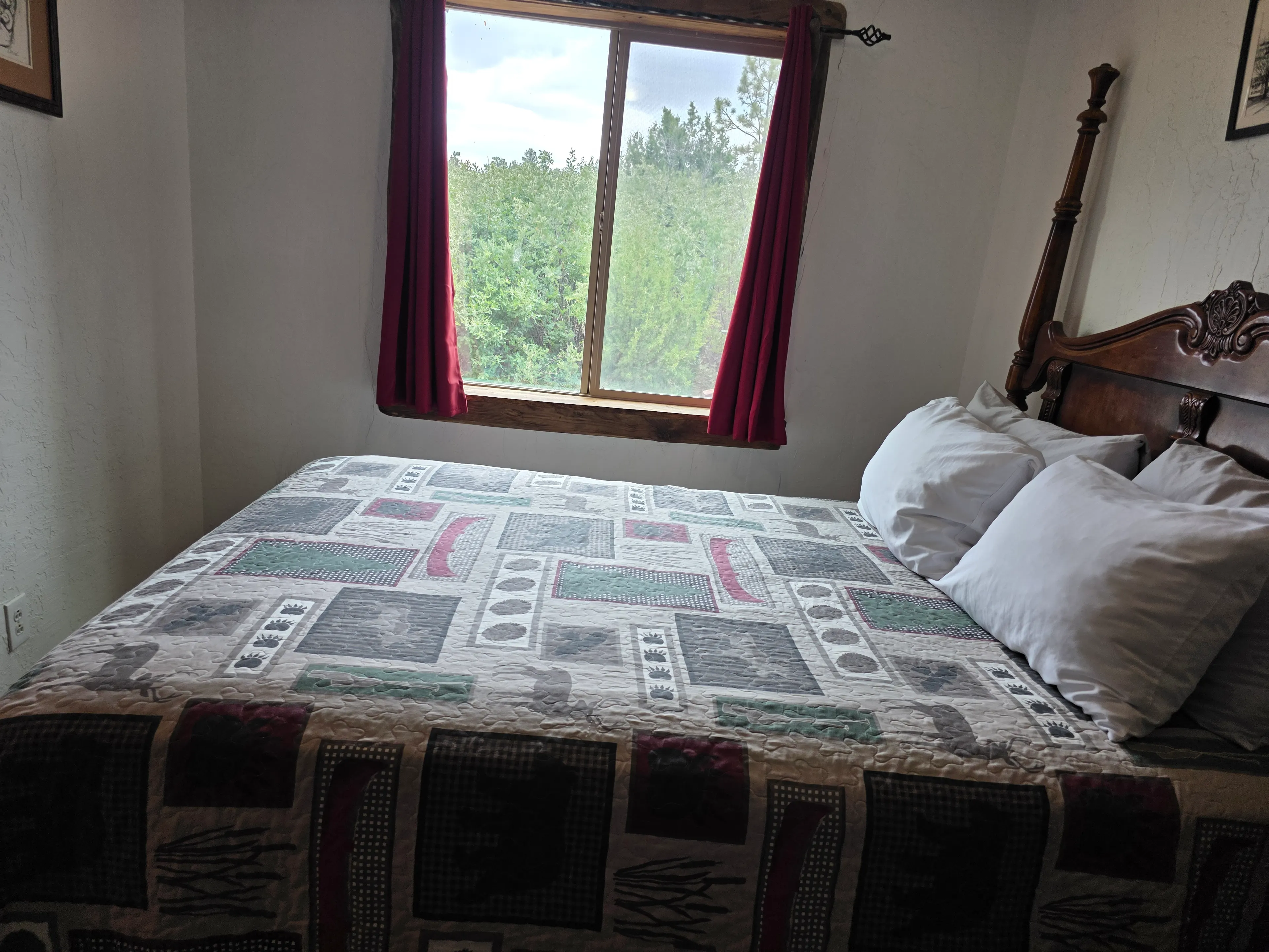 queen bed with forest window