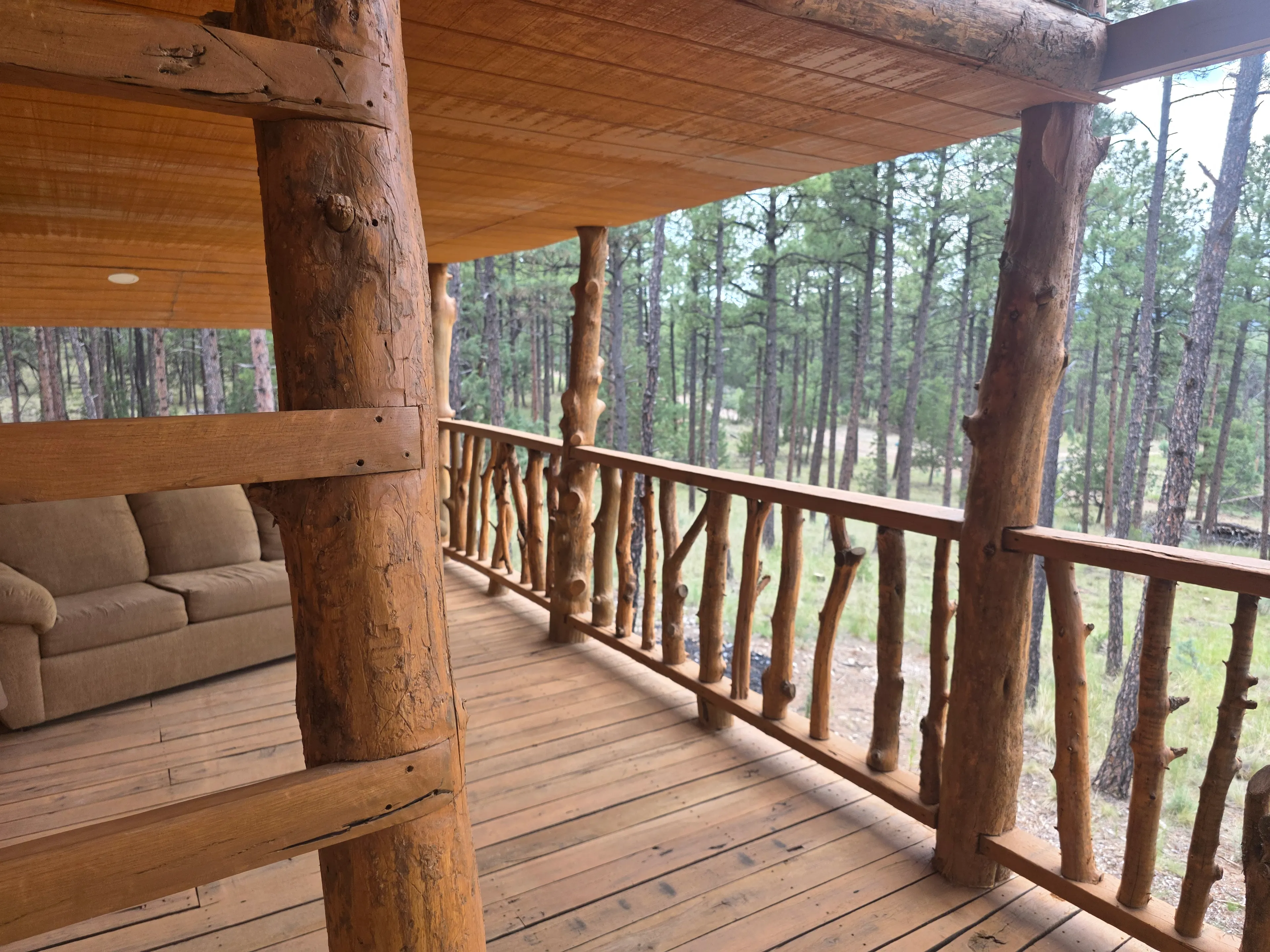covered porch with log railing