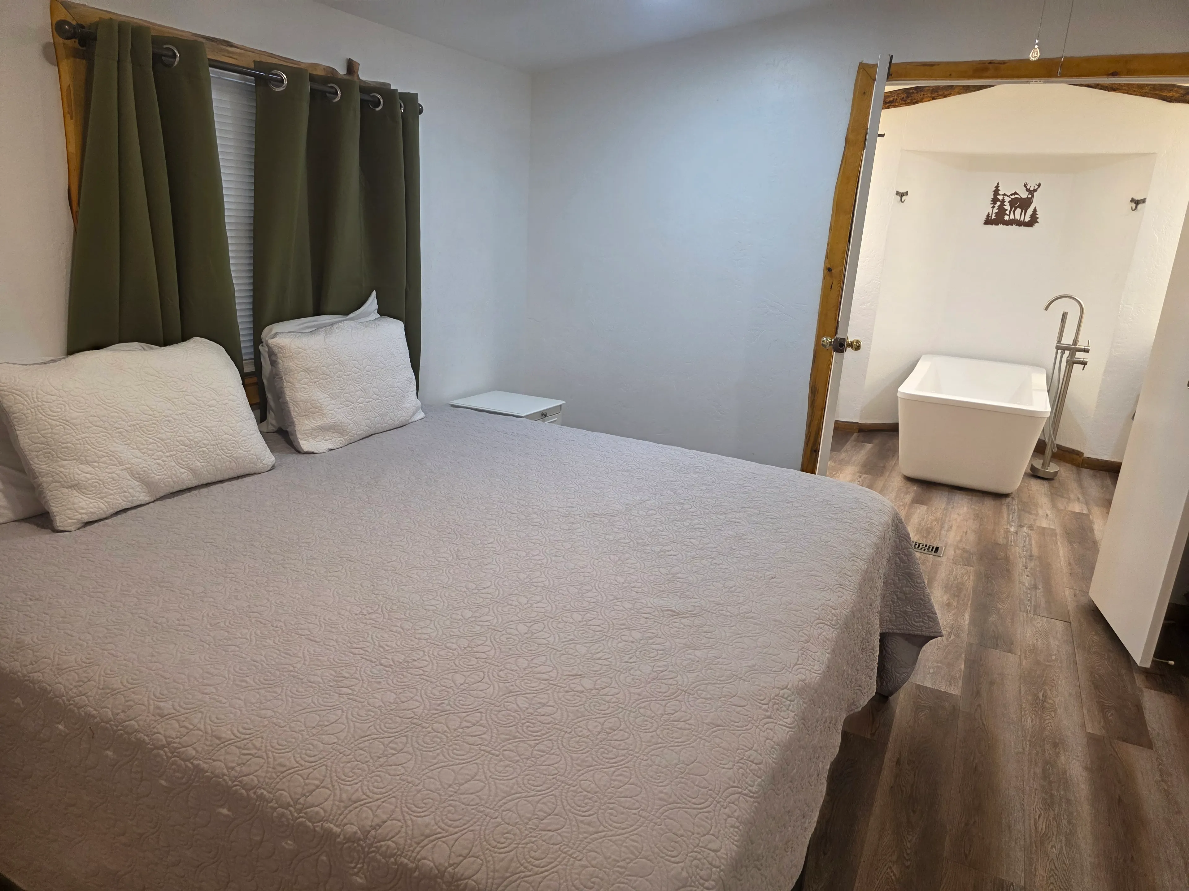 bedroom with ensuite soaking tub