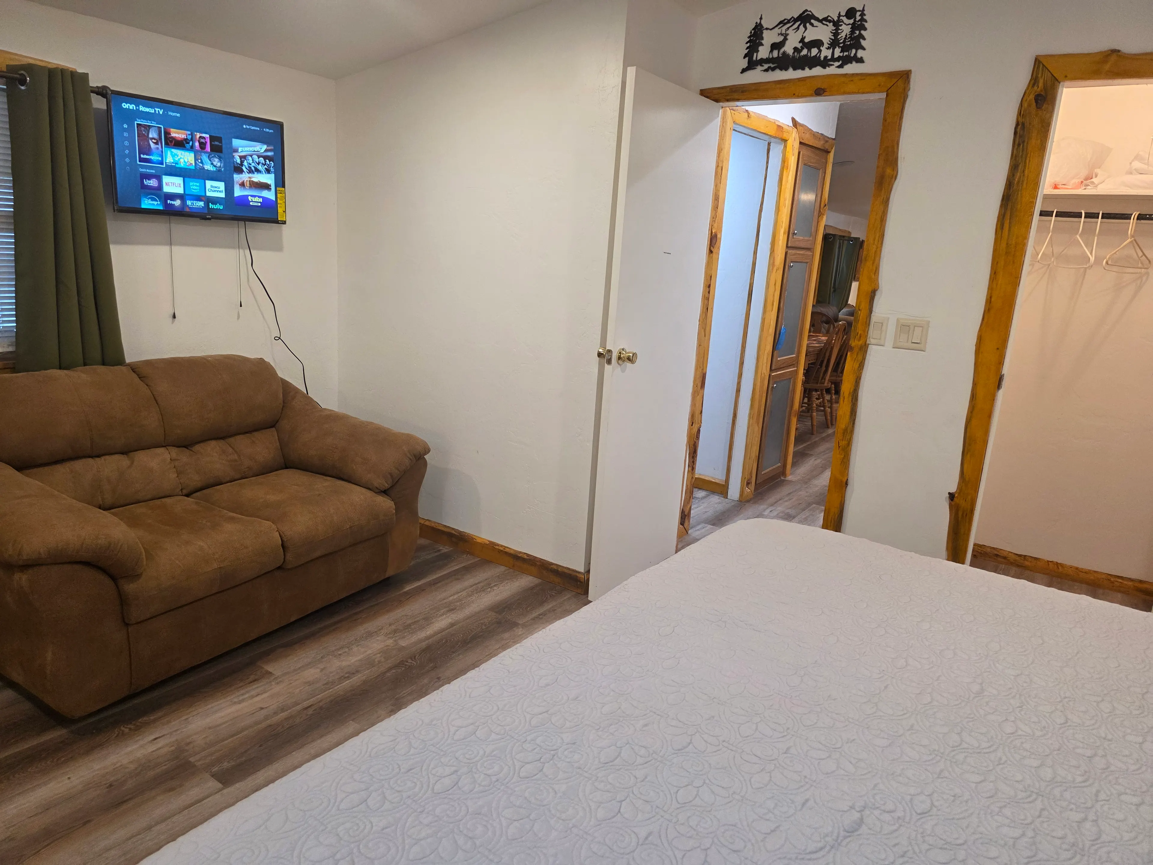 bedroom sitting area with wall TV