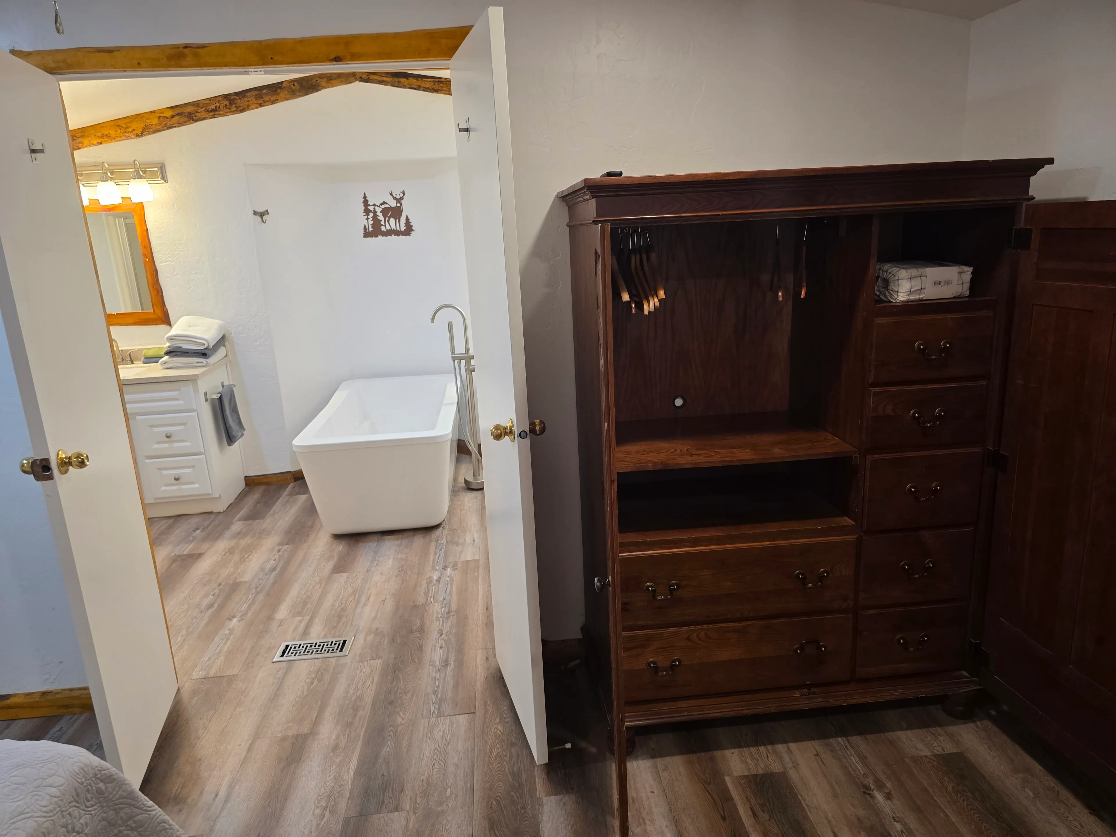 armoire and view into ensuite bathroom