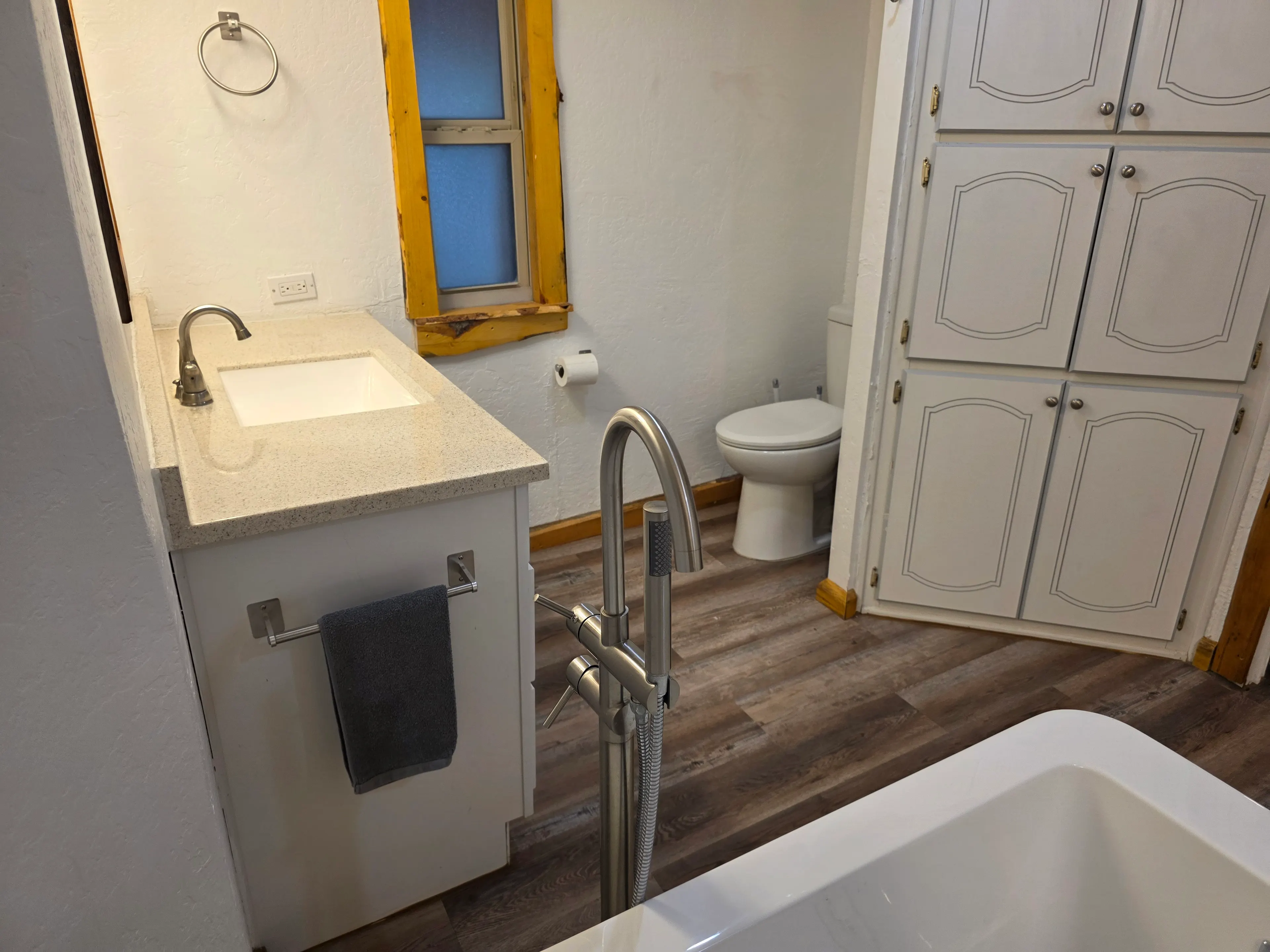 bathroom vanity, toilet and tub
