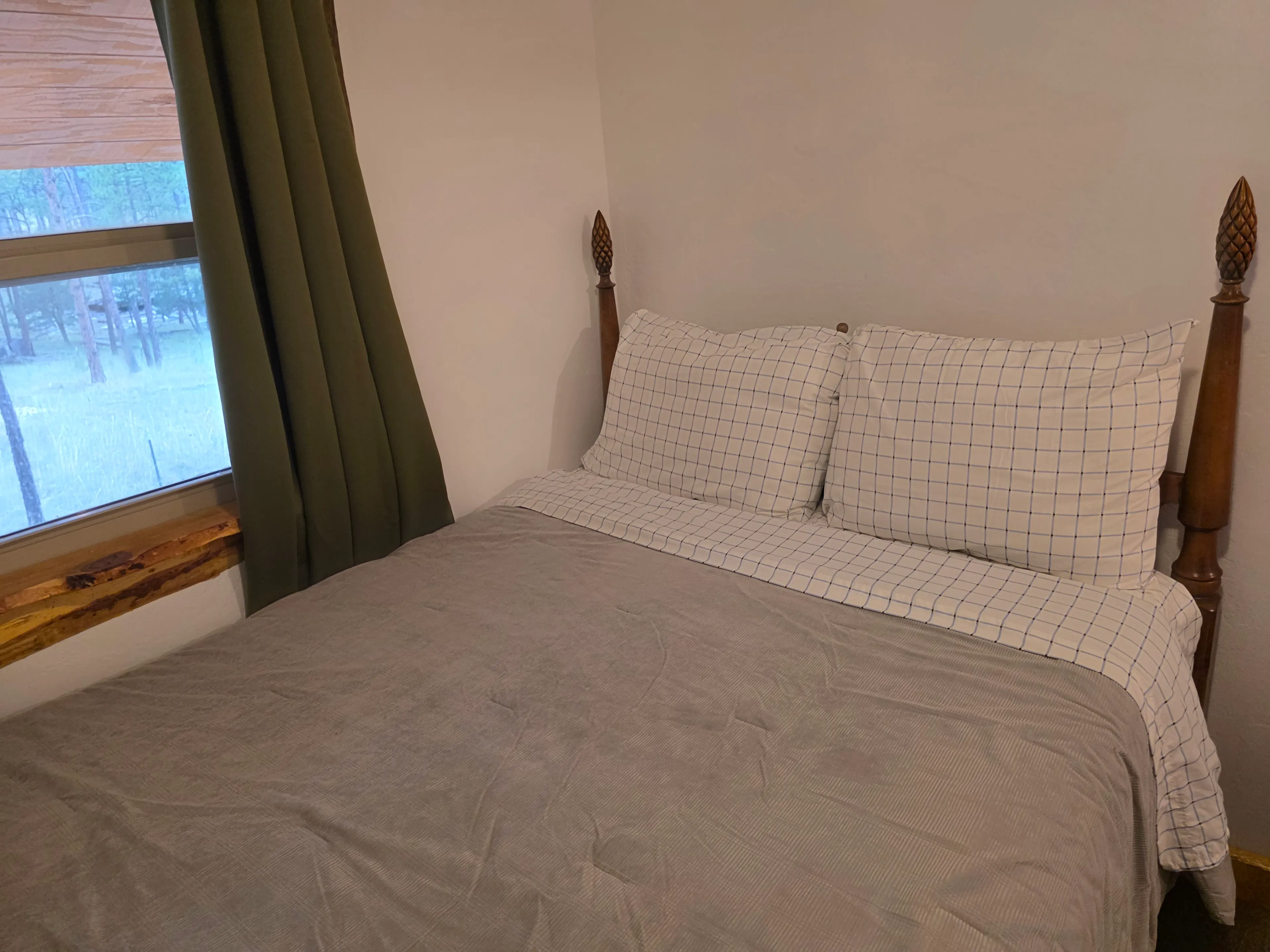 queen bed with forest window view