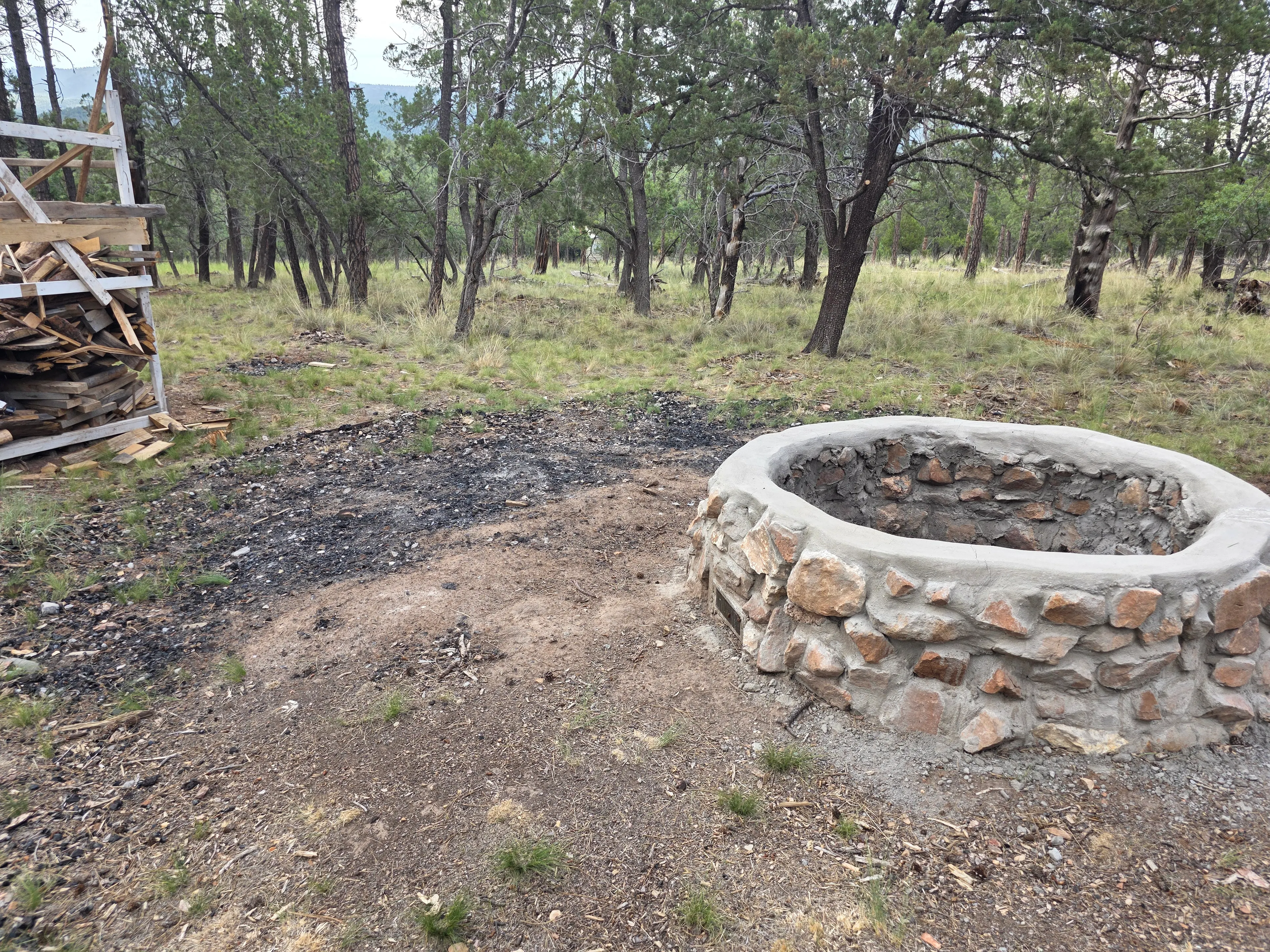 stone fire pit and firewood rack