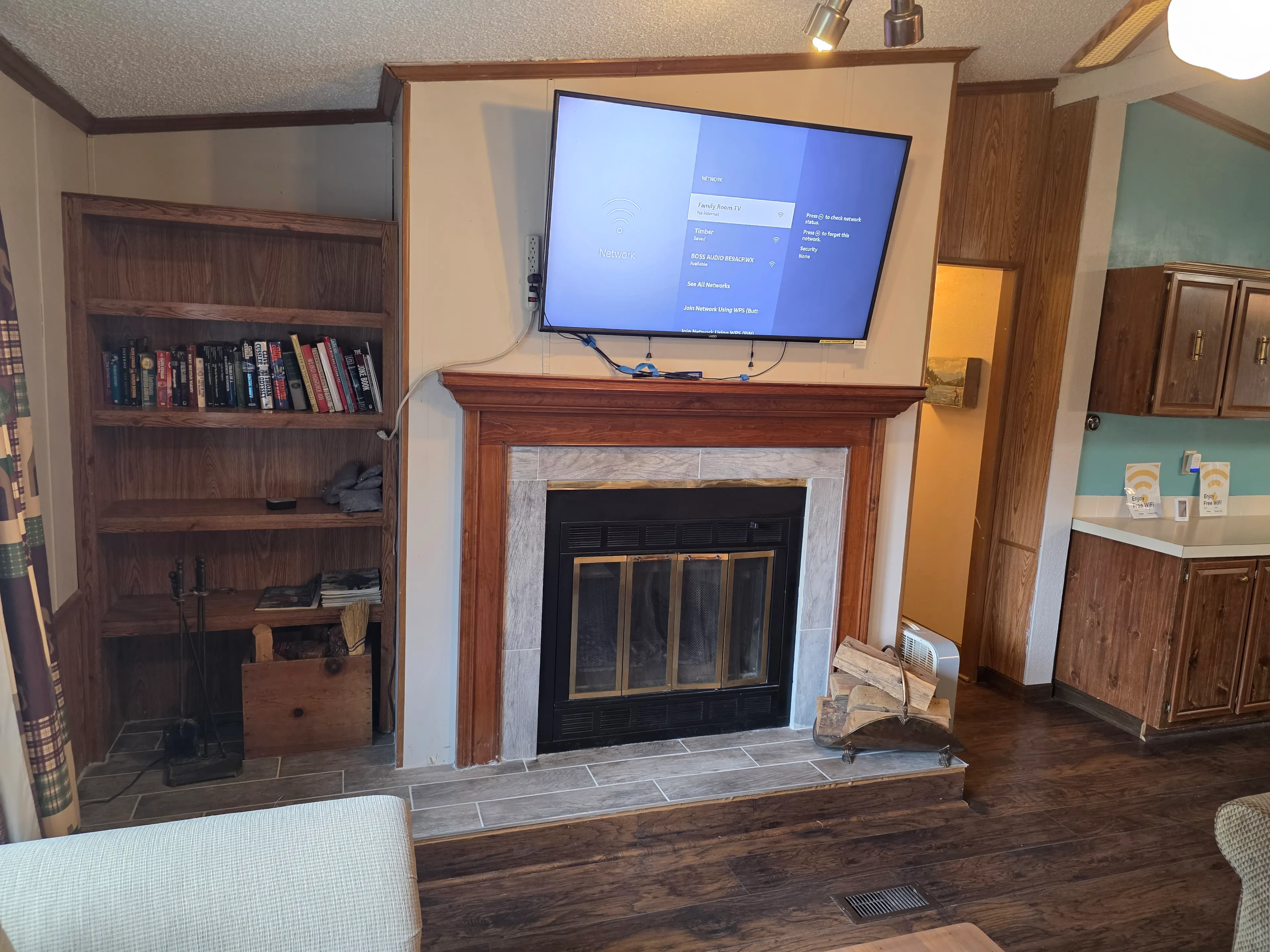 TV above fireplace, book shelves