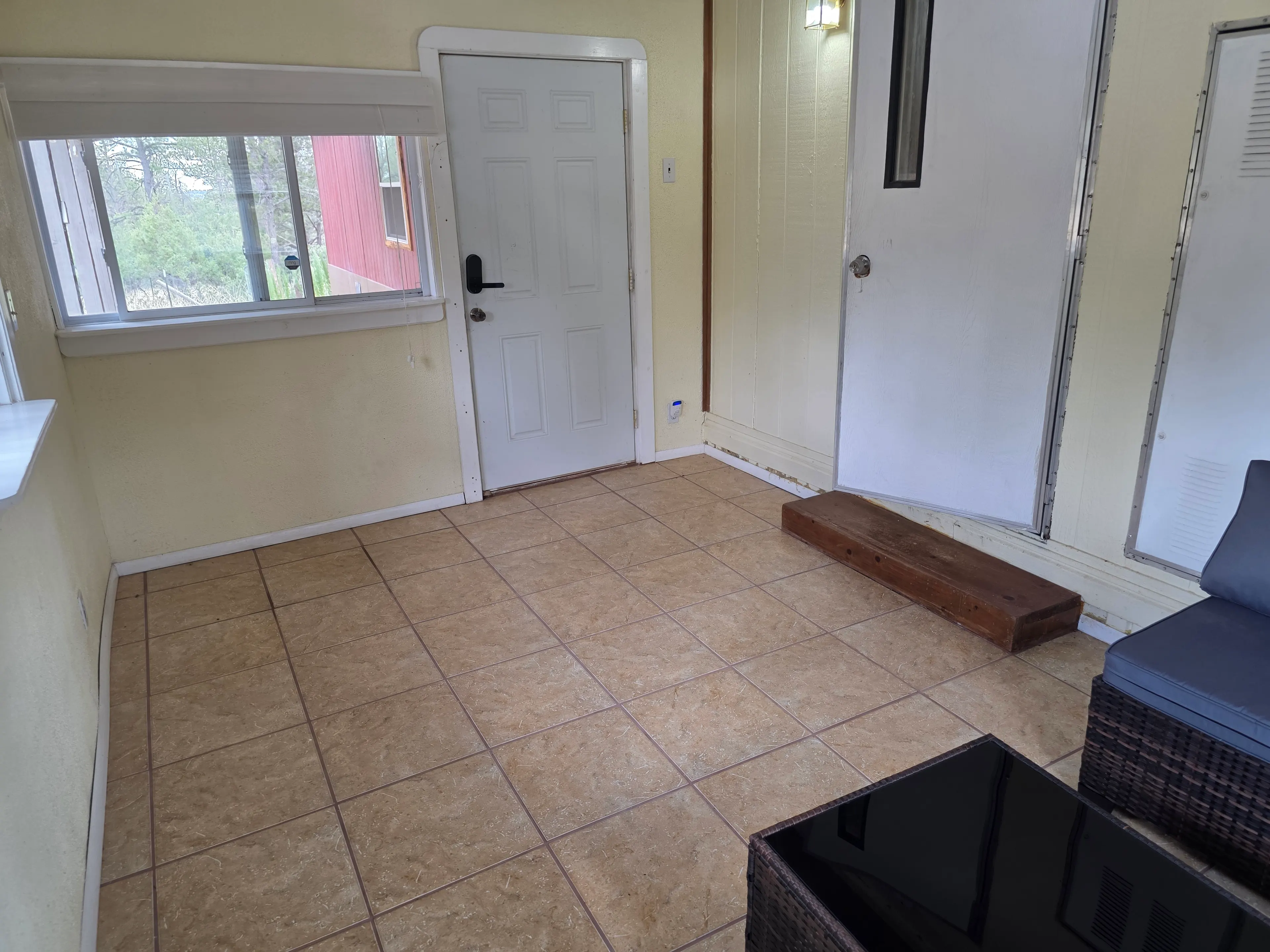 tiled sunroom entry door area