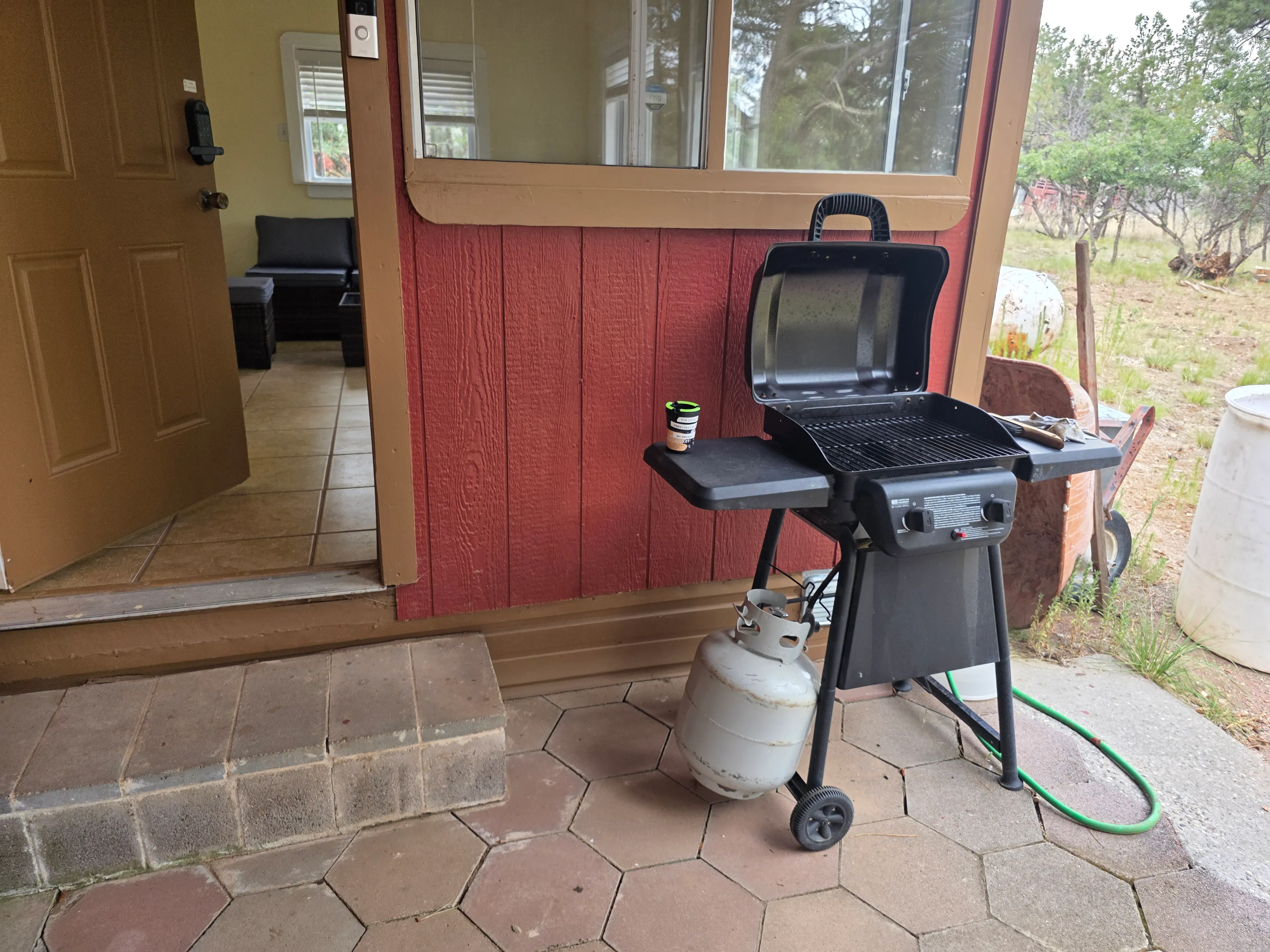 propane grill by cabin door